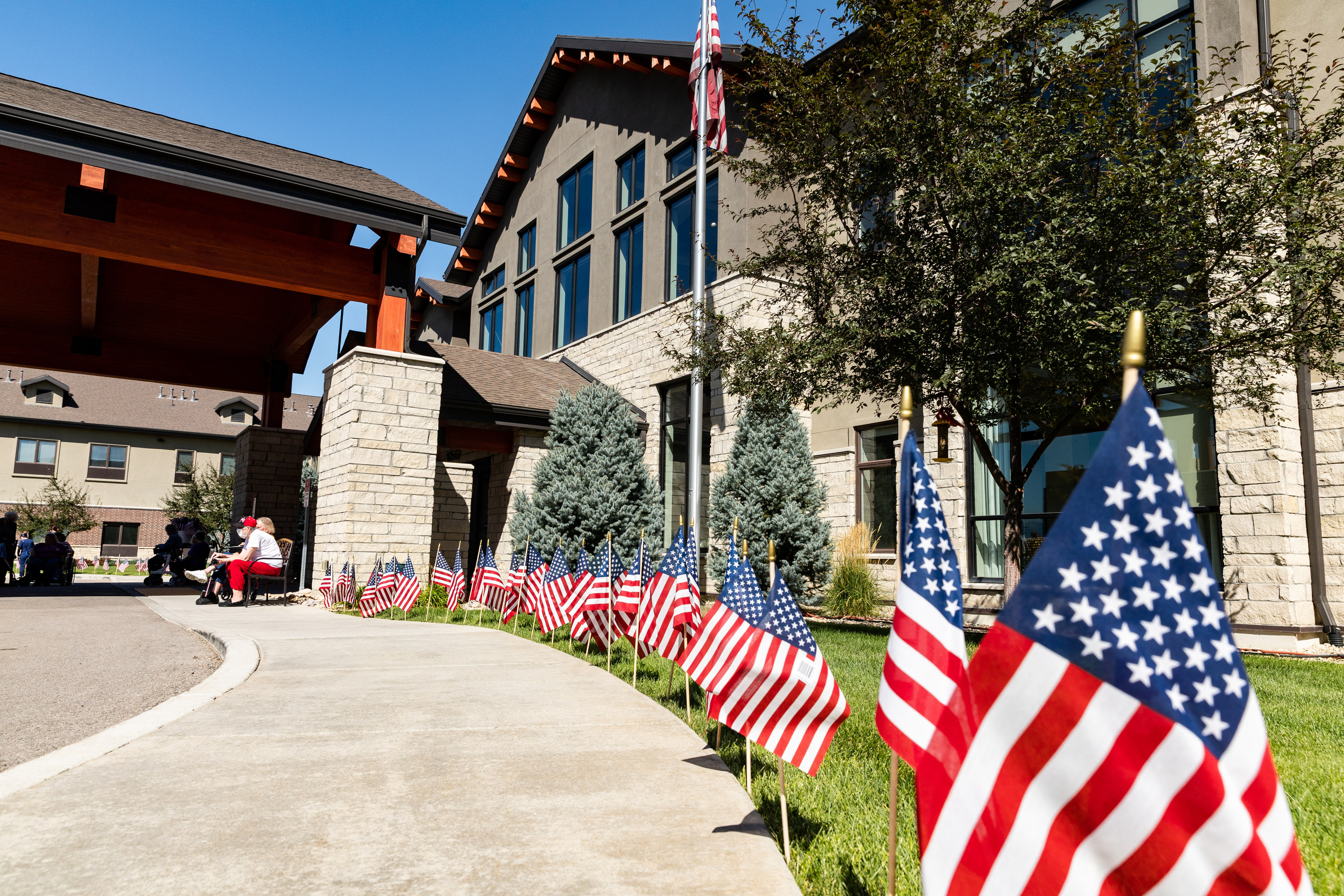 Flags line the front of Copper Creek Senior Living in South Jordan on Monday. Every resident was invited to put up a flag and share with caretakers where they were on 9/11 as part of a memorial tribute.