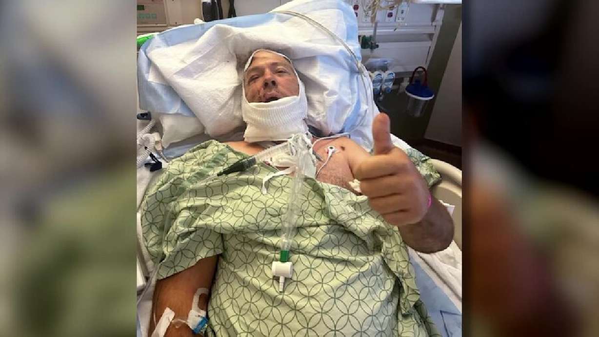 Rudy Noorlander gives a thumbs up sign from his hospital bed at the University of Utah in Salt Lake City after being attacked by a bear in Montana Friday.