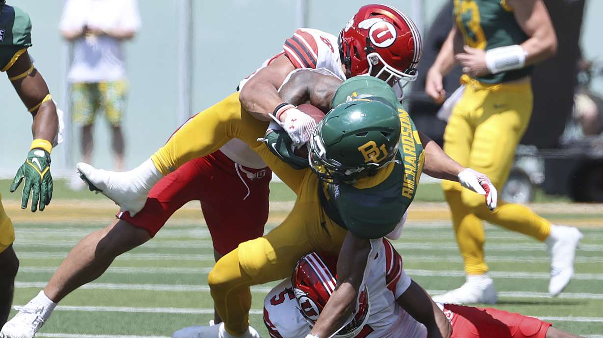 Baylor running back Dominic Richardson (21) is tackled by Utah safety Sione Vaki (28) and Utah cornerback Zemaiah Vaughn (5) in the second half of an NCAA college football game, Saturday, Sept. 9, 2023, in Waco, Texas.