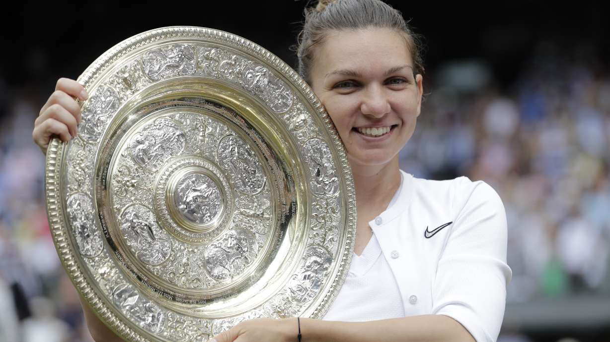 FILE - Romania's Simona Halep holds the trophy after defeating Serena Williams in the women's singles final of the Wimbledon Tennis Championships in London, July 13, 2019. Two-time Grand Slam champion Simona Halep has been suspended from professional tennis for four years for alleged doping violations, the International Tennis Integrity Agency said Tuesday, Sept. 12, 2023.