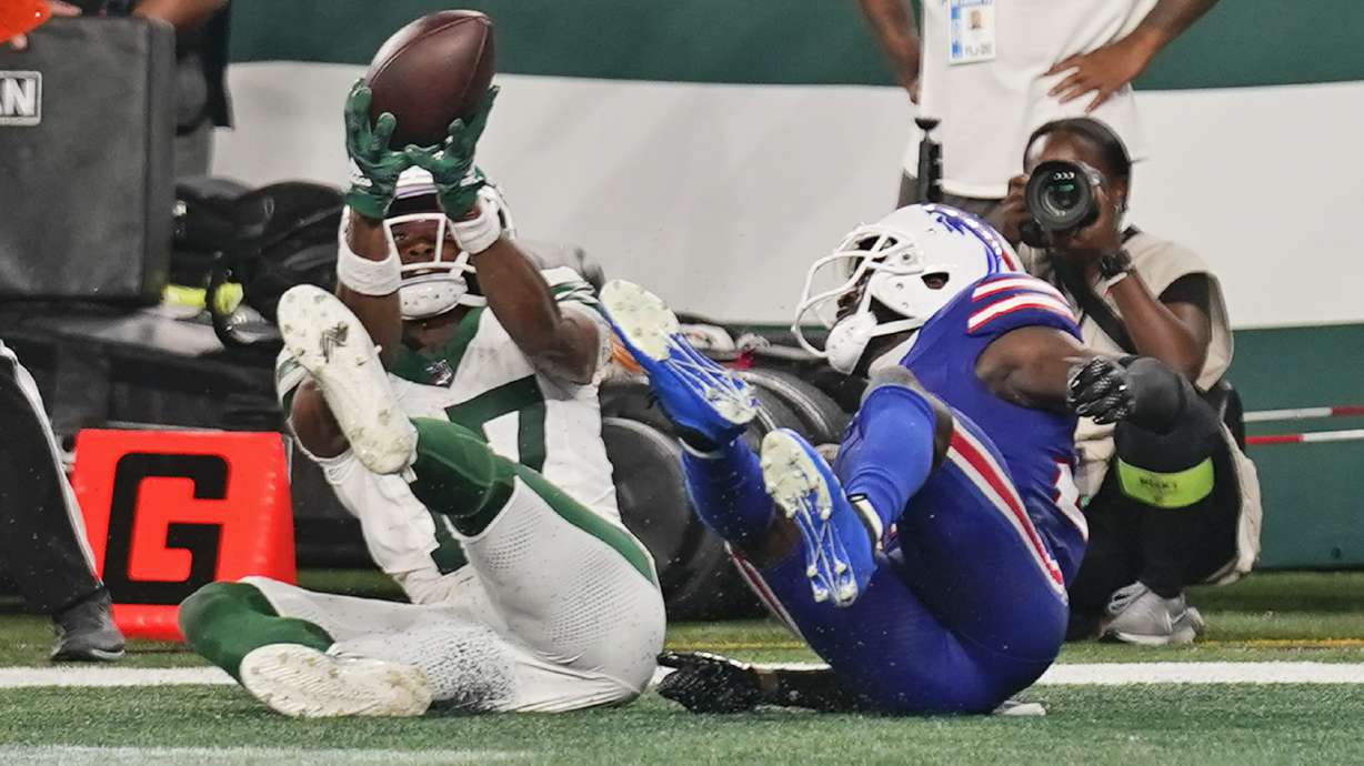New York Jets wide receiver Garrett Wilson (17), left, makes a touchdown catch against Buffalo Bills cornerback Tre'Davious White (27) during the fourth quarter of an NFL football game, Monday, Sept. 11, 2023, in East Rutherford, N.J.
