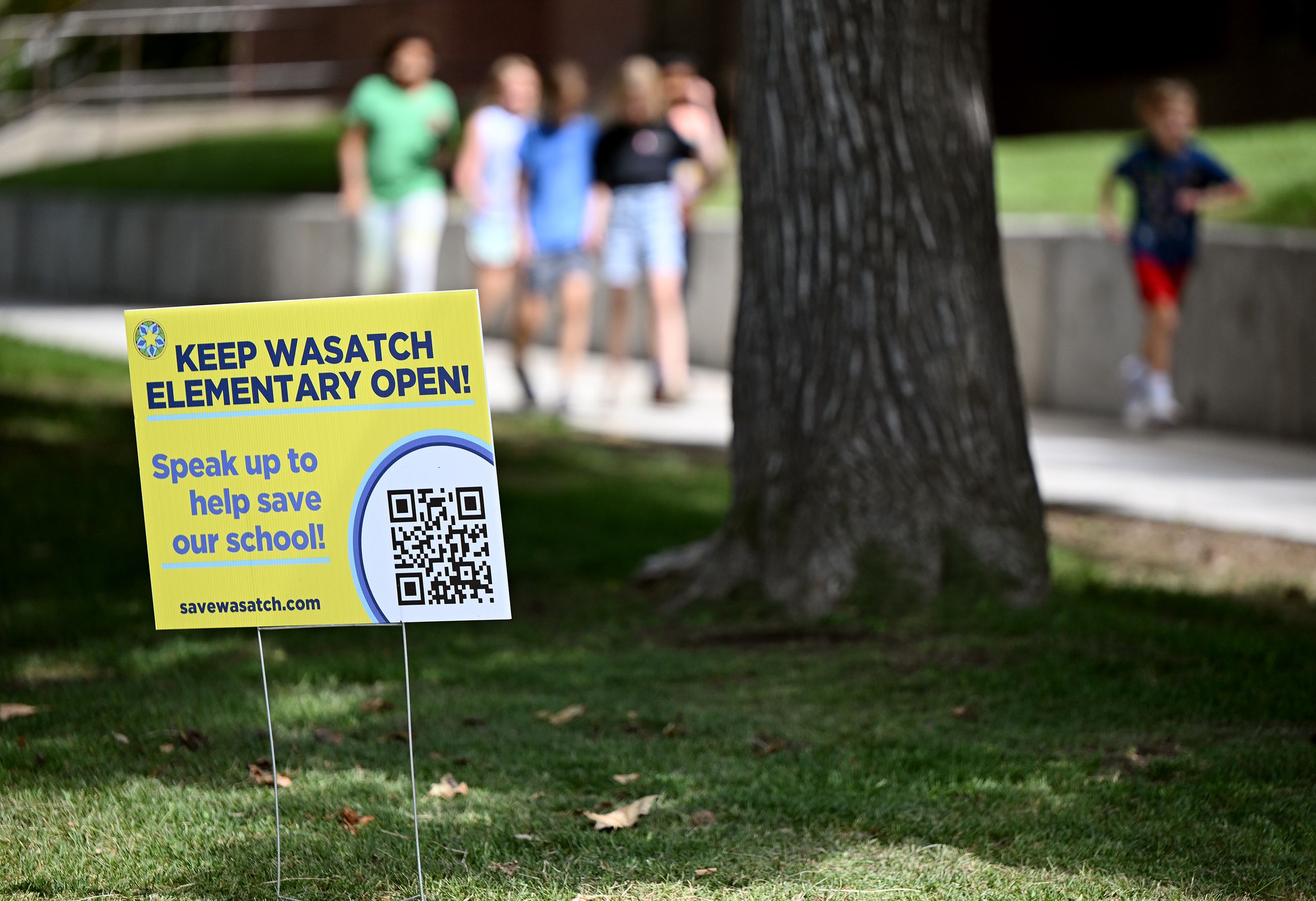Students from Wasatch Elementary School hurry down the sidewalk for recess on Tuesday. The school is one of seven schools that the Salt Lake City School District is considering closing.