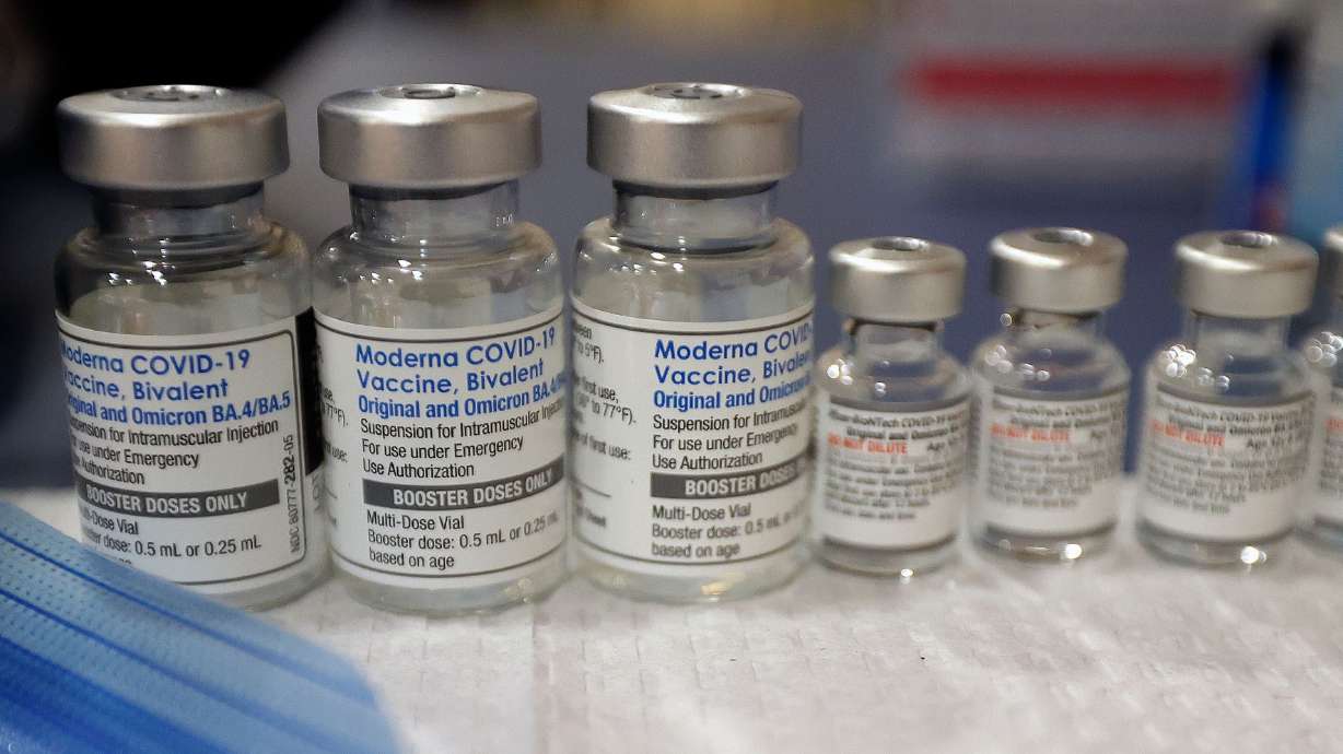 Vials of the Moderna and Pfizer COVID-19 bivalent booster are pictured at a free vaccine clinic at the Sanderson Community Center in Taylorsville on Nov. 9, 2022. Everyone 6 months and older should get an updated COVID-19 shot, the Centers for Disease Control and Prevention recommended Tuesday.
