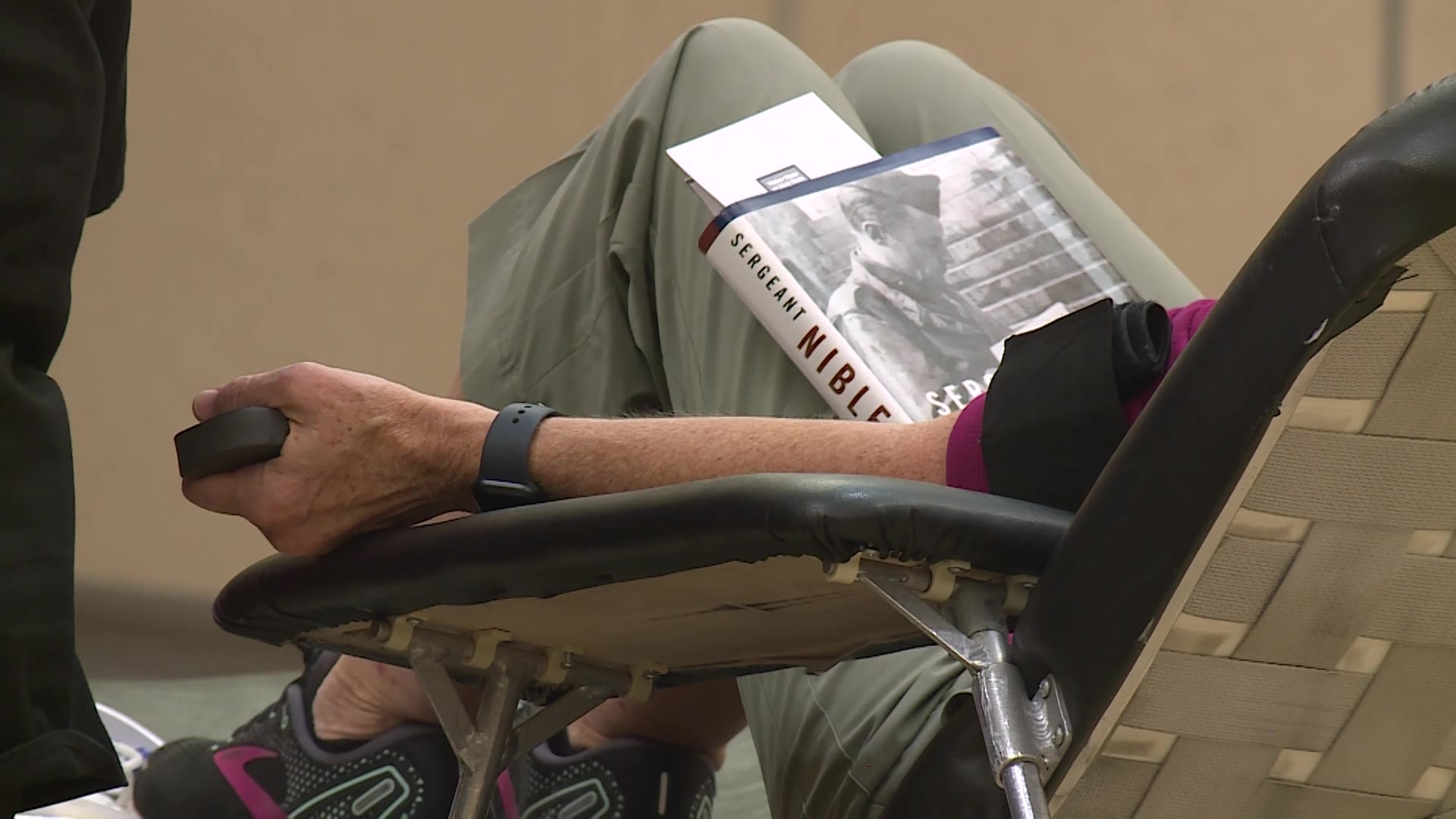 A donor reading a book while giving blood on Tuesday at Weber State University in Ogden.