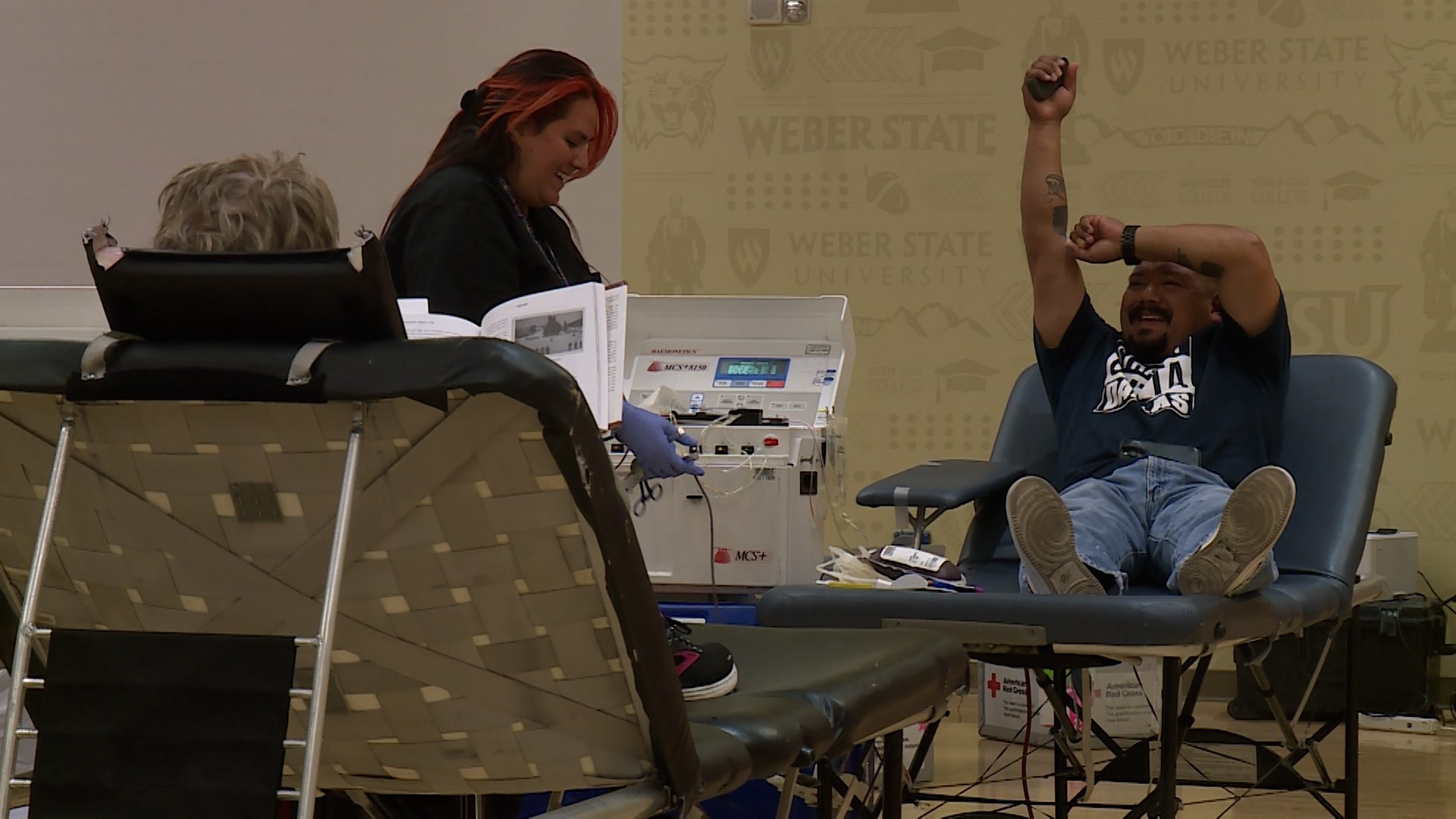 A donor lifting his hand to help with blood circulation at Weber State University in Ogden.