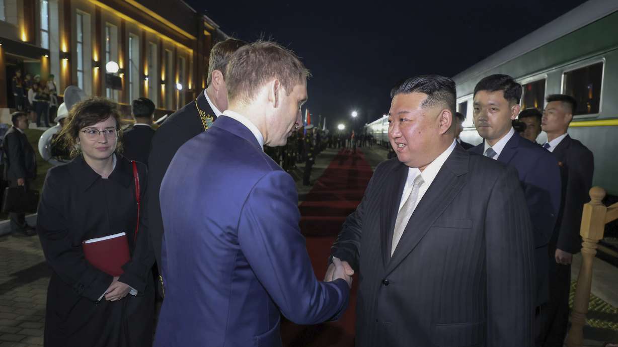 North Korea's leader Kim Jong Un is greeted by Russian Minister of Natural Resources and Ecology Alexander Kozlov after crossing the border to Russia at Khasan, about 79 miles south of Vladivostok on Tuesday.