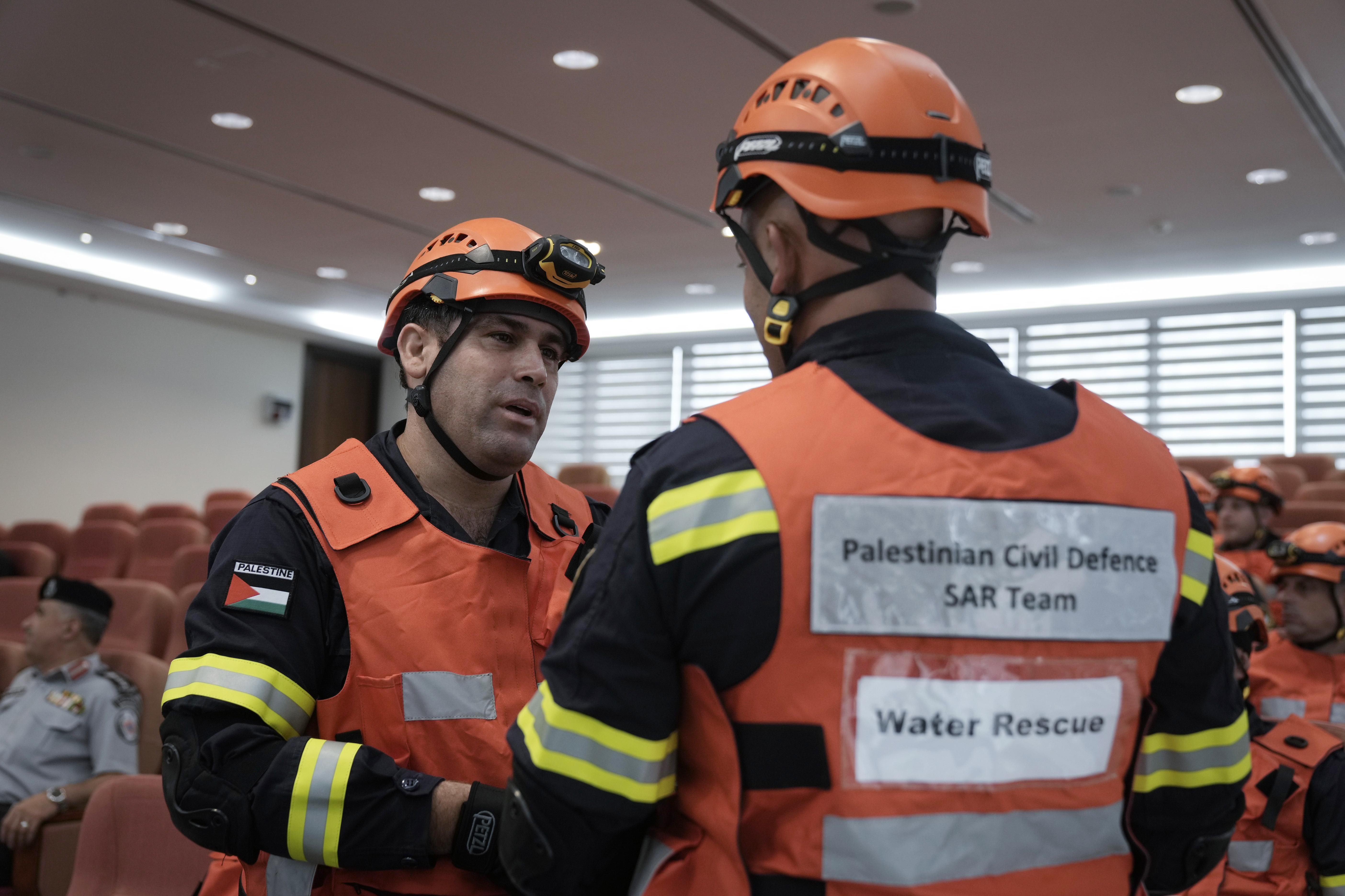 Palestinian civil defense team members listen to a briefing before leaving for a mission to assist flood-stricken Libya, in the West Bank city of Ramallah, Wednesday. Palestinian medics and civil defense forces are headed to Libya to join relief and assistance efforts for victims affected by the cyclone that devastated the country.