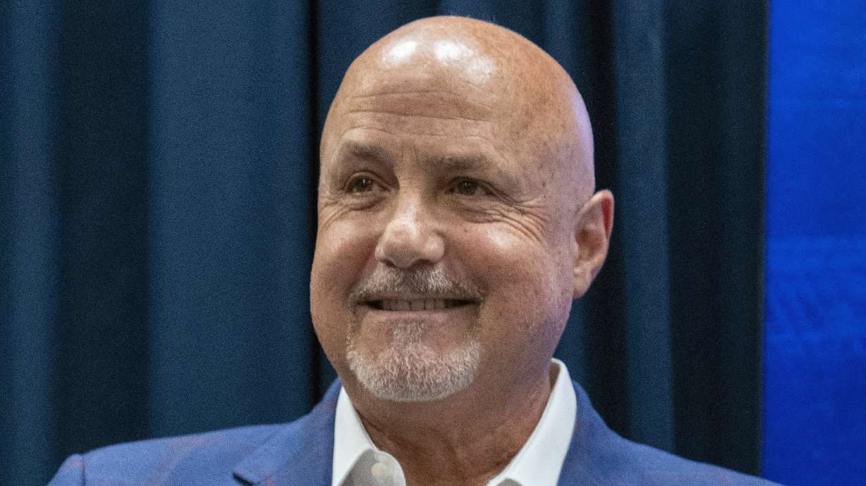 FILE - Washington Nationals general manager Mike Rizzo smiles during a media availability at Nationals Park, Saturday, July 22, 2023, in Washington. The Nationals are giving longtime president of baseball operations and general manager Mike Rizzo a chance to finish what he started. The club signed Rizzo to a multi-year extension on Wednesday, Sept. 13.