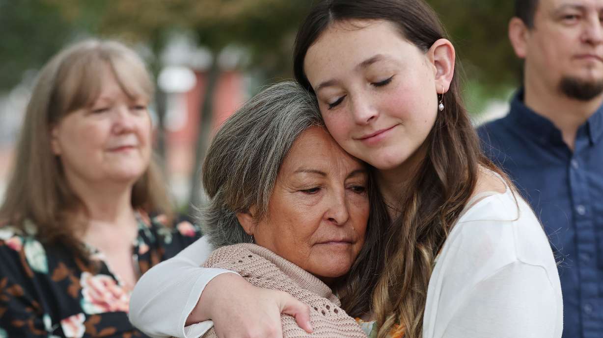 Brenda Robbs hugs her great-niece Lexi Waters as family members held a press conference Wednesday in Salt Lake City to discuss the 1980 killing of their relative. Salt Lake police are looking for further help in the investigation.