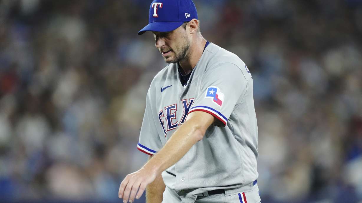 Texas Rangers starting pitcher Max Scherzer stretches his arm as he leaves the team's baseball game against the Toronto Blue Jays with an injury during the sixth inning Tuesday, Sept. 12, 2023, in Toronto.