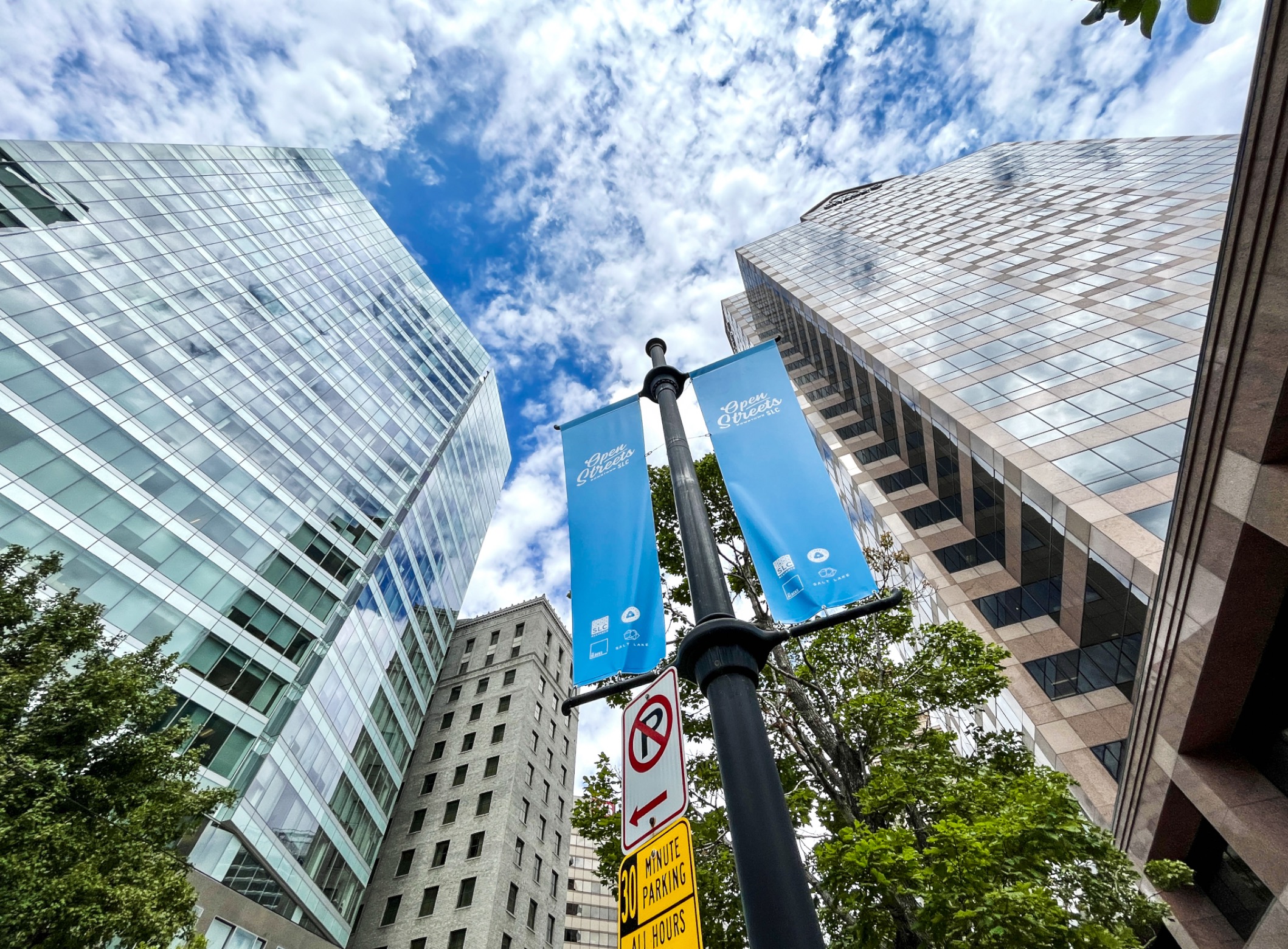 Banners promoting Open Streets posted along Main Street in Salt Lake City. The street will be closed to cars from noon to 1 a.m. every Friday and Saturday beginning this weekend and continuing through Oct. 28.
