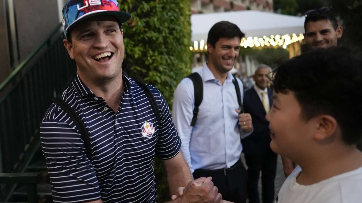 USA Ryder Cup team captain Zach Johnson shakes hands with a fan as he returns with members of his team at a hotel in Rome, Friday, Sept. 8, 2023, at the end of a practice session at the Marco Simone golf club.