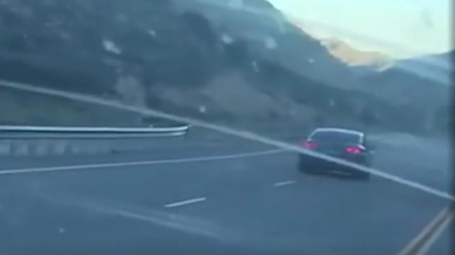 Karrie Palmer recorded video of this car as it passed her illegally, straddled two lanes, and hit a curb.