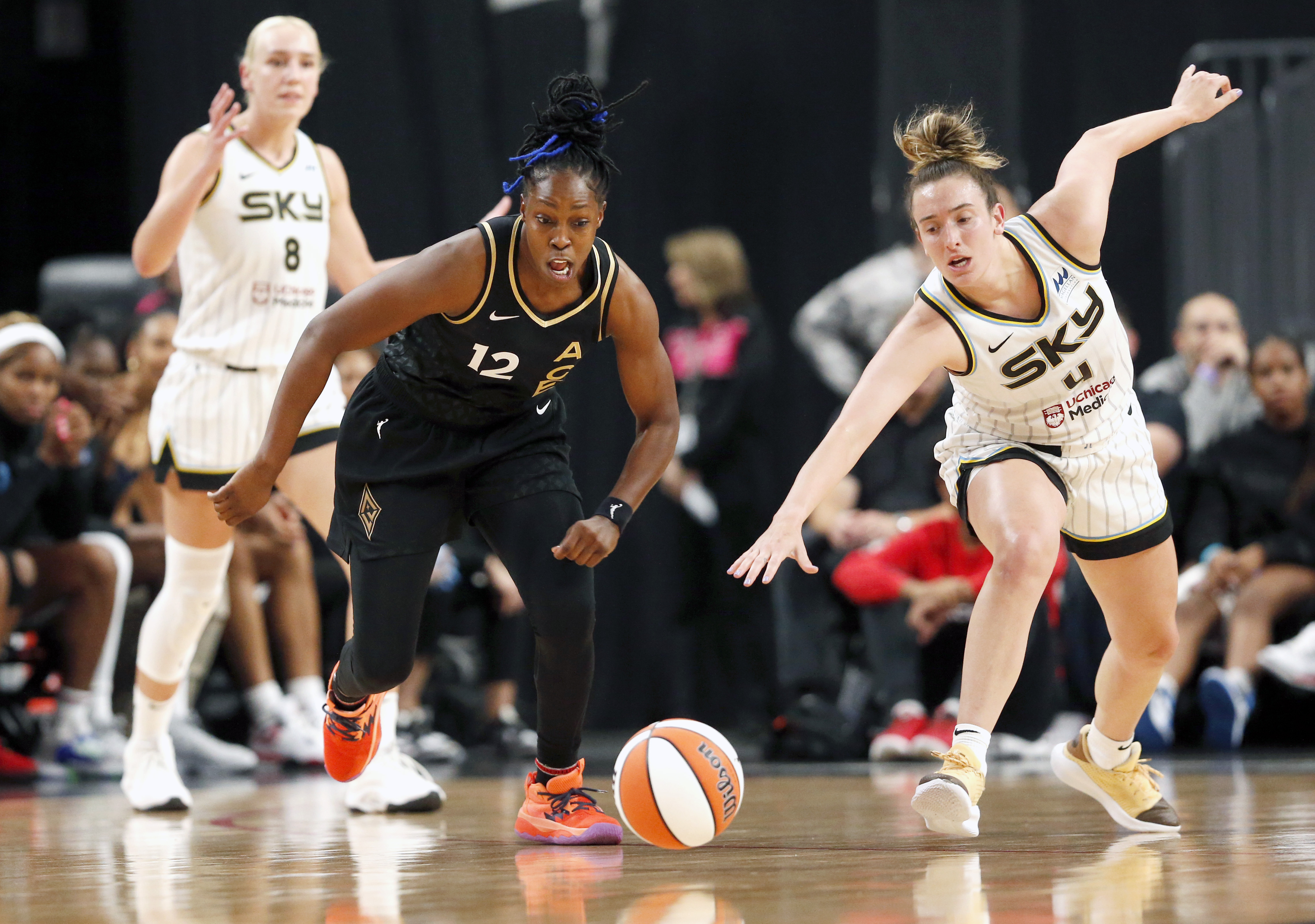 Las Vegas Aces guard Chelsea Gray (12) and Chicago Sky guard Marina Mabrey (4) chase the ball during the first half of Game 1 in a first-round WNBA basketball playoff series Wednesday, Sept. 13, 2023, in Las Vegas. Sky forward Alanna Smith is at left. 