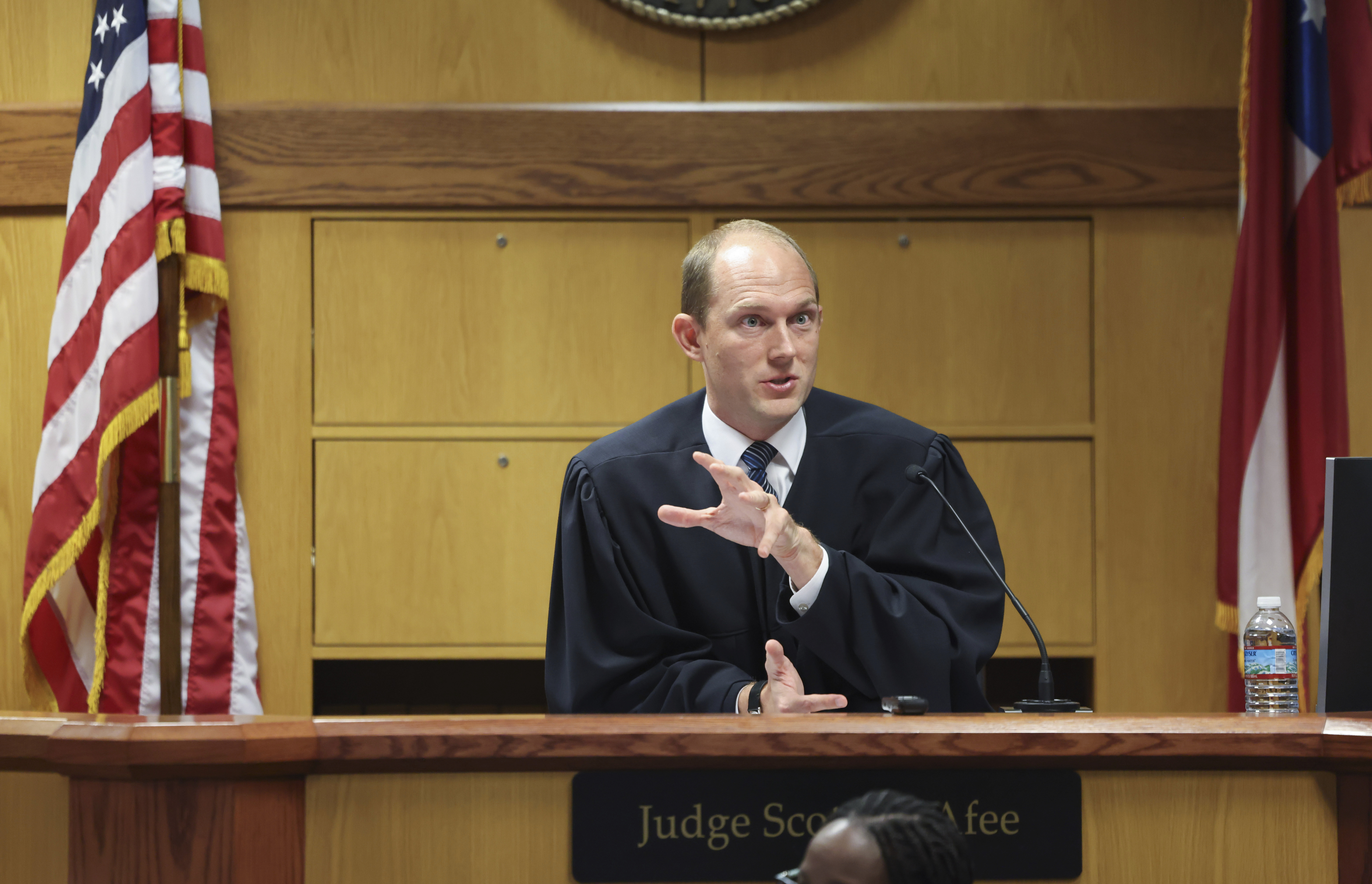 Fulton County Superior Judge Scott McAfee prepares to hear motions from attorneys representing Ken Chesebro and Sidney Powell in Atlanta on Sept. 6. 
