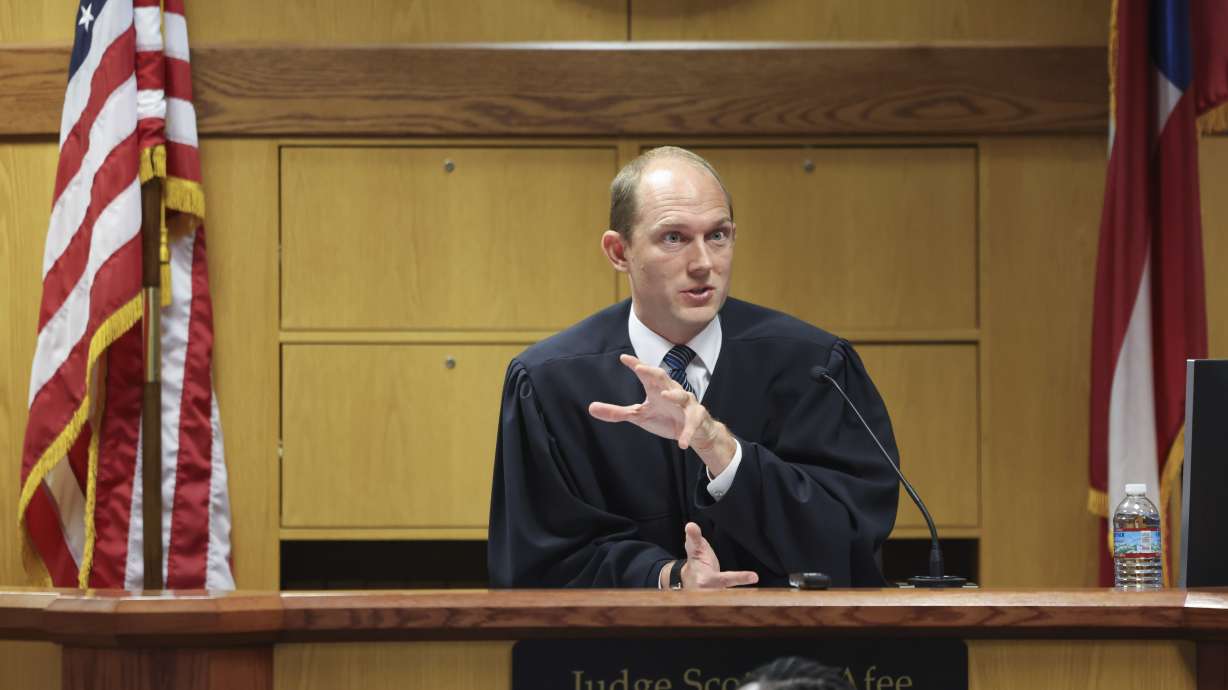 Fulton County Superior Judge Scott McAfee prepares to hear motions from attorneys representing Ken Chesebro and Sidney Powell in Atlanta on Sept. 6.