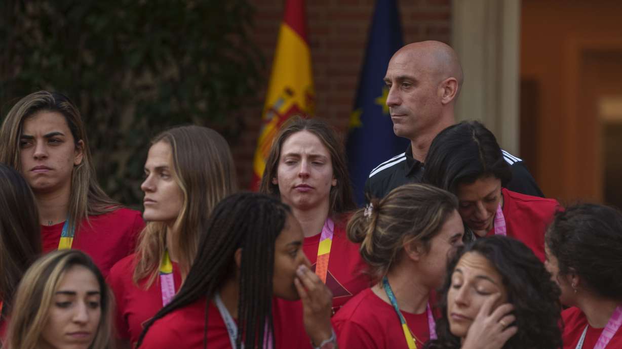 FILE - Then President of Spain's soccer federation, Luis Rubiales, top right, stands with Spain's Women's World Cup soccer team after their World Cup victory at La Moncloa Palace in Madrid, Spain, on Aug. 22, 2023. One day before Spain’s new women’s coach announces her first squad, the players who won the Women’s World Cup have yet to say if they are ready to come back to the team after rebelling against their disgraced former federation president. Spain’s women have had little chance to celebrate their greatest soccer achievement because Luis Rubiales caused an uproar when he kissed a player on the lips without her consent at the awards ceremony last month in Sydney.