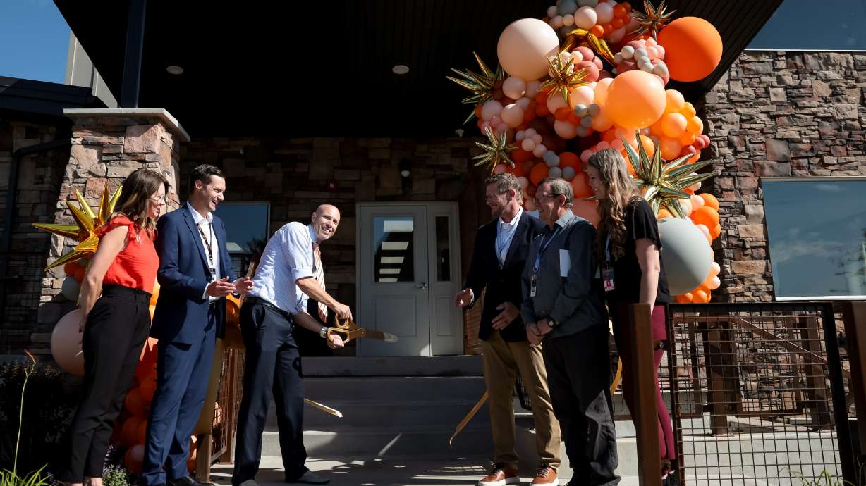 Matty Bryant, academic director at Spark Academy, cuts the ribbon for the school’s new building in Provo on Thursday.