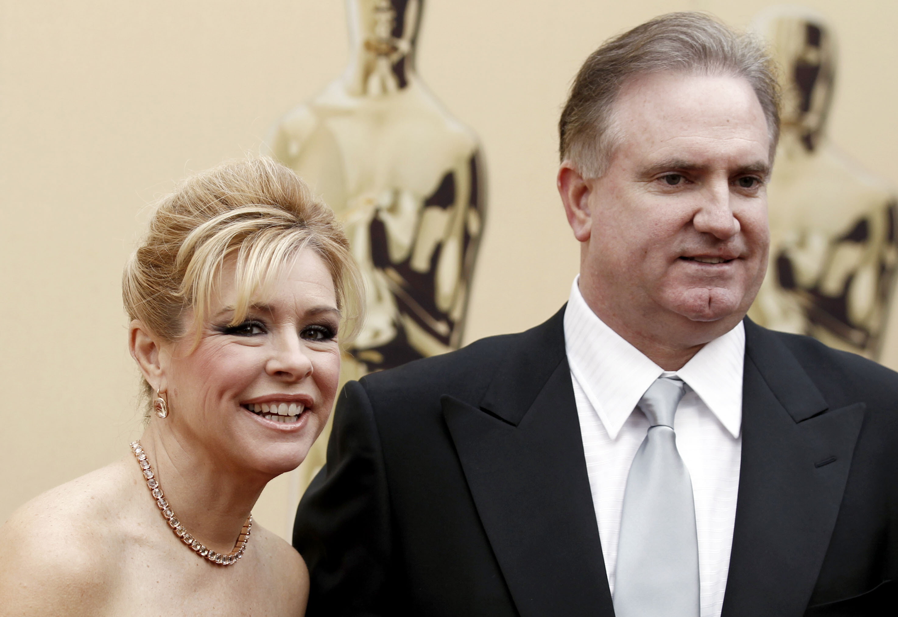 Leigh Ann Tuohy and Sean Tuohy arrives during the 82nd Academy Awards, March 7, 2010. The Memphis couple who took in former NFL offensive lineman Michael Oher when he was in high school denied in court documents filed Thursday that they used a legal agreement between them to get rich at his expense and lied about intending to adopt him.