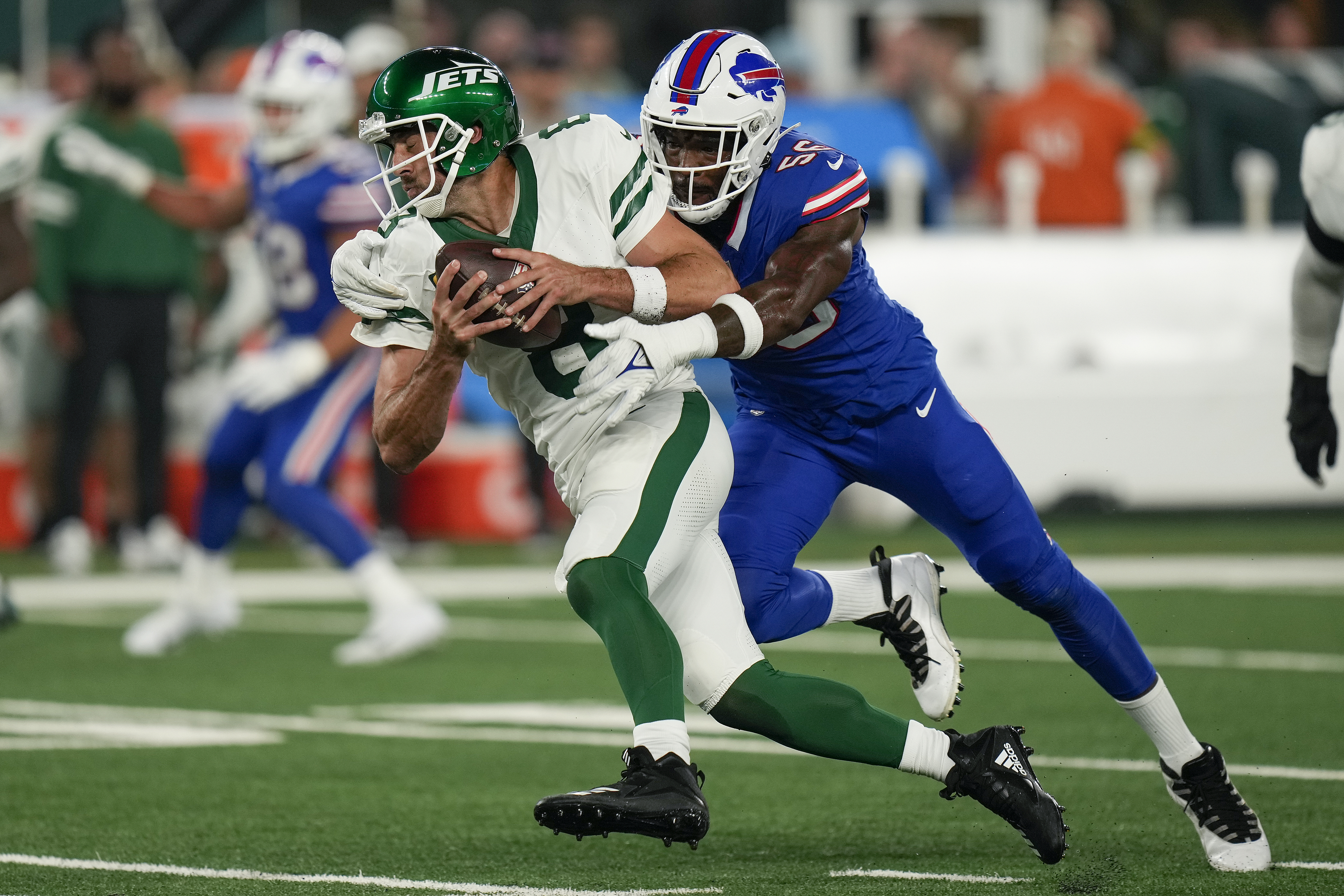 New York Jets quarterback Aaron Rodgers (8) is sacked by Buffalo Bills defensive end Leonard Floyd (56) during the first quarter of an NFL football game, Monday, Sept. 11, 2023, in East Rutherford, N.J.