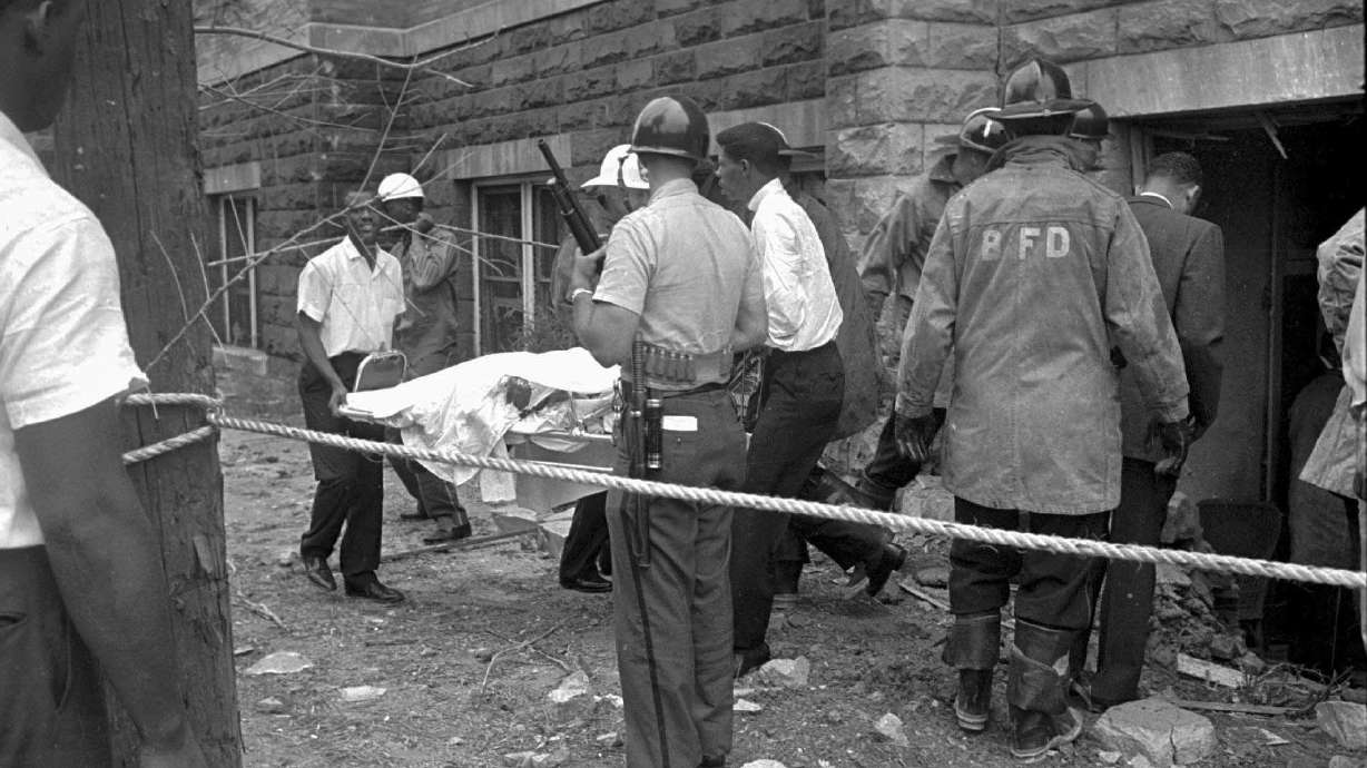Firefighters and ambulance attendants remove a covered body from the 16th Street Baptist Church in Birmingham, Ala., Sept. 15, 1963, after a deadly explosion detonated by members of the Ku Klux Klan during services. Friday will mark the 60th anniversary of the bombing that killed four girls.