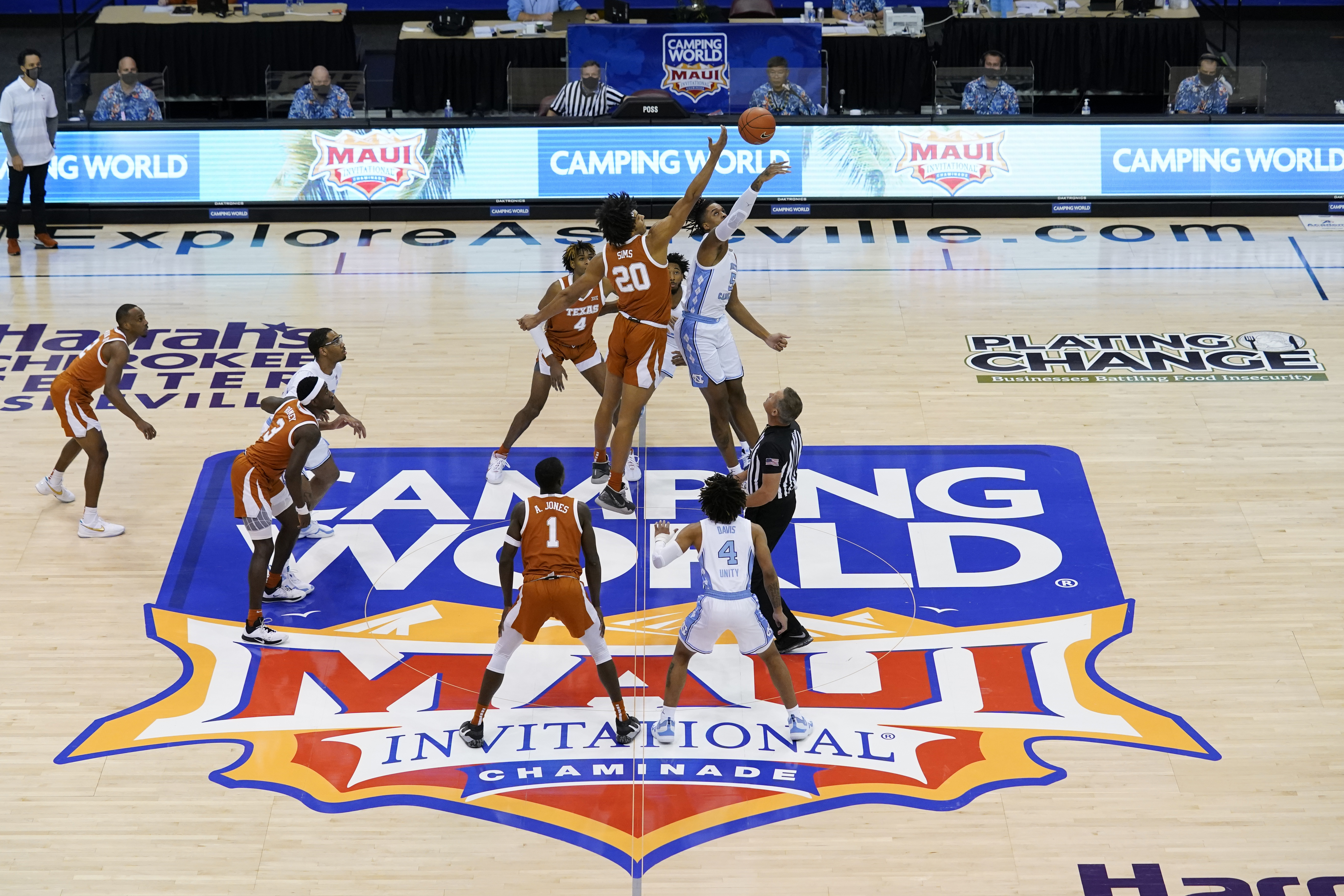 FILE - Texas forward Jericho Sims (20) and North Carolina forward Armando Bacot (5) tip off for the start of an NCAA college basketball game for the championship of the Maui Invitational, Wednesday, Dec. 2, 2020, in Asheville, N.C. The Maui Invitational will be played in Honolulu this year because of the wildfire that devastated Lahaina where the tournament usually is played.