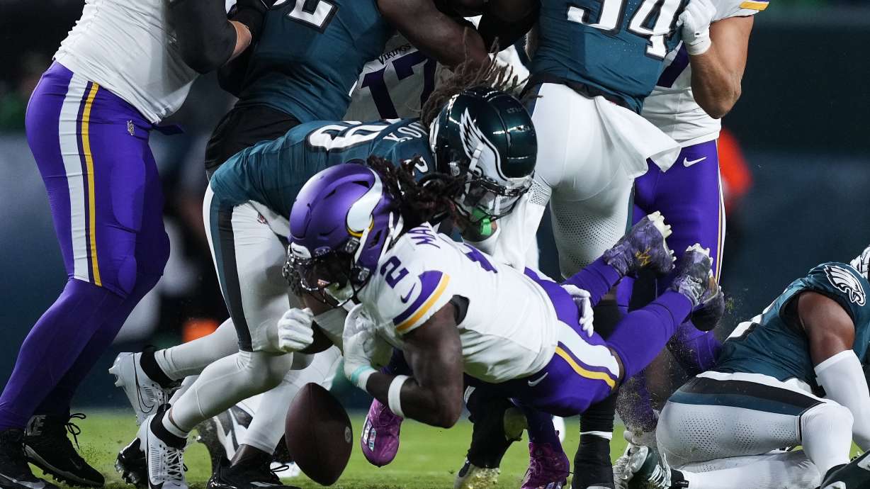 Minnesota Vikings running back Alexander Mattison (2) fumbles the ball during the first half of an NFL football game against the Philadelphia Eagles on Thursday, Sept. 14, 2023, in Philadelphia.