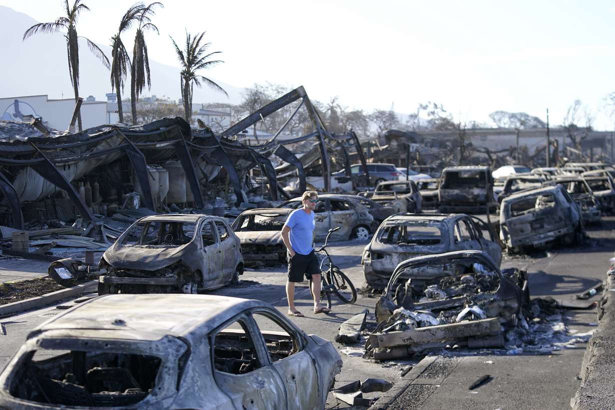 A man walks through wildfire wreckage Aug. 11, in Lahaina, Hawaii. Maui authorities said Sept. 14, that they are planning to start letting residents and business owners make escorted visits to their properties in the restricted Lahaina Wildfire Disaster area later this month.