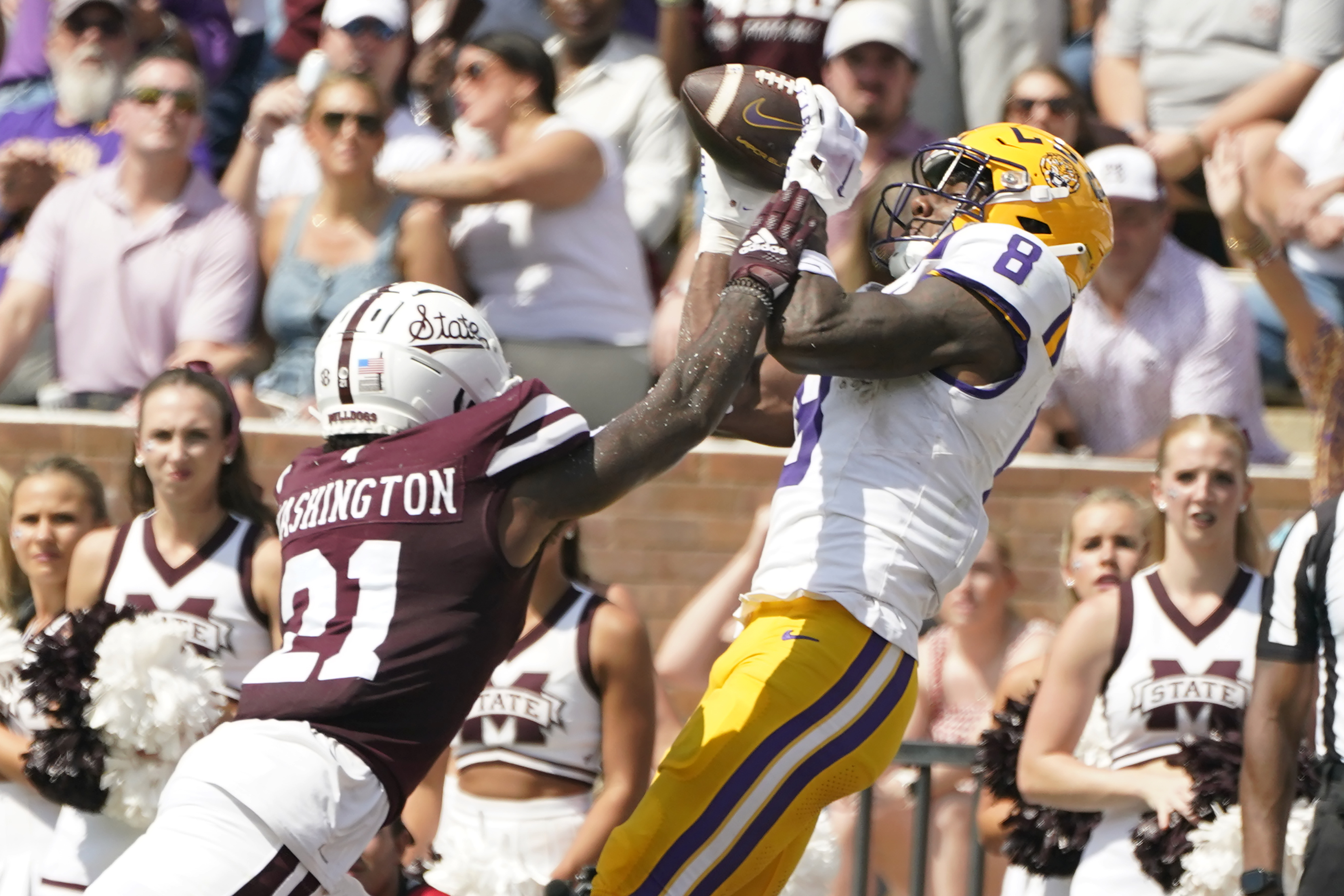 LSU wide receiver Malik Nabers (8) catches a 26-yard touchdown pass reception over the defense of Mississippi State safety Hunter Washington (21) during the first half of an NCAA college football game, Saturday, Sept. 16, 2023, in Starkville, Miss.