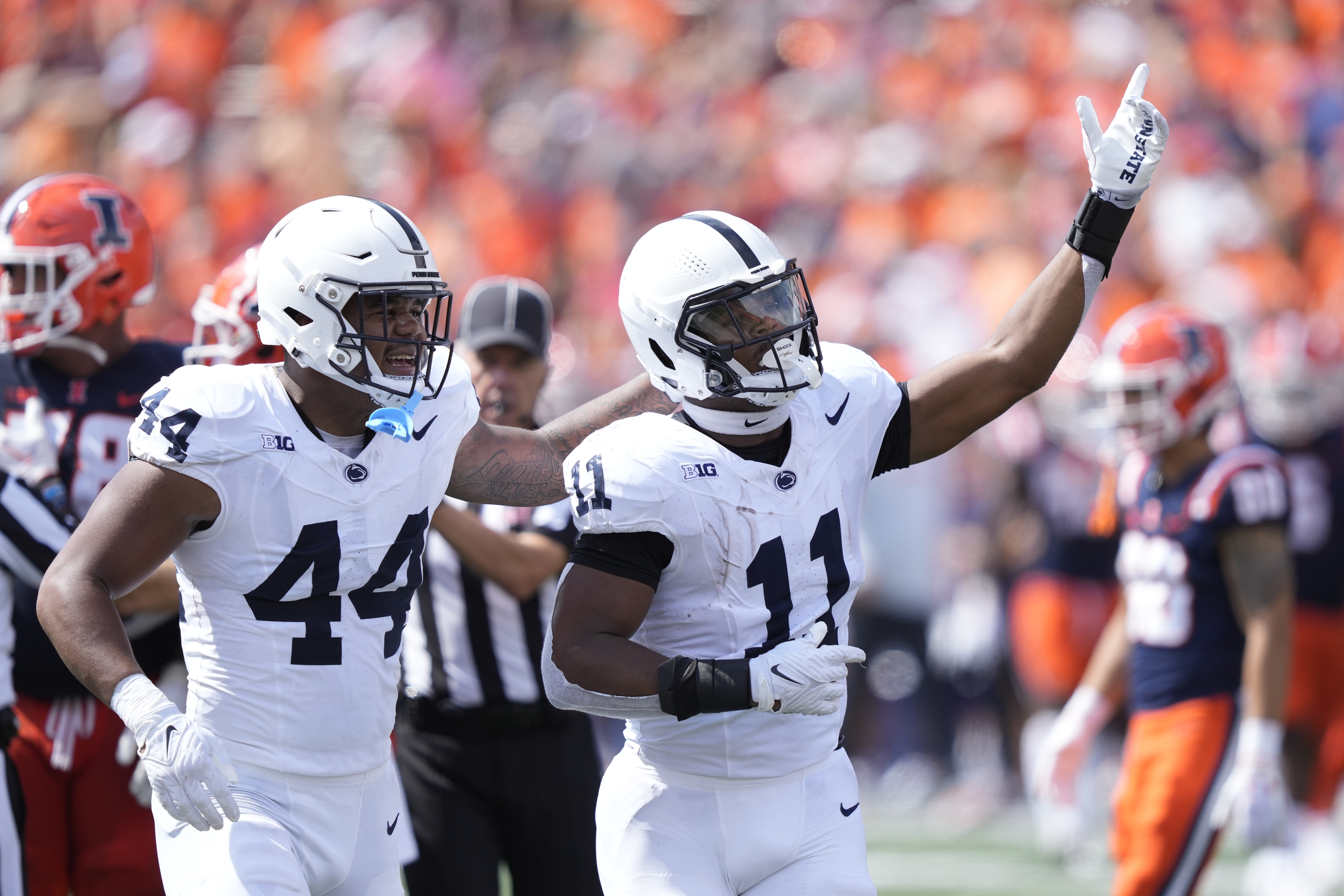 Penn State linebacker Abdul Carter (11) celebrates his interception with Chop Robinson during the first half of an NCAA college football game against Illinois, Saturday, Sept. 16, 2023, in Champaign, Ill. 