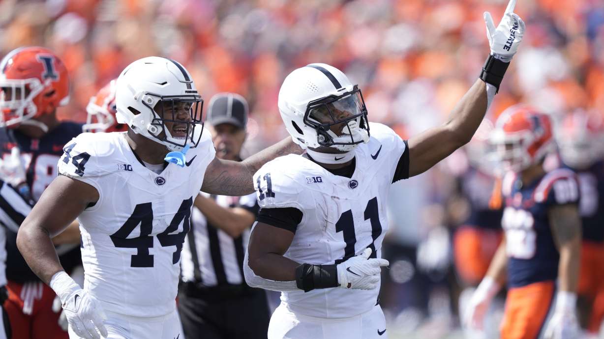 Penn State linebacker Abdul Carter (11) celebrates his interception with Chop Robinson during the first half of an NCAA college football game against Illinois, Saturday, Sept. 16, 2023, in Champaign, Ill.