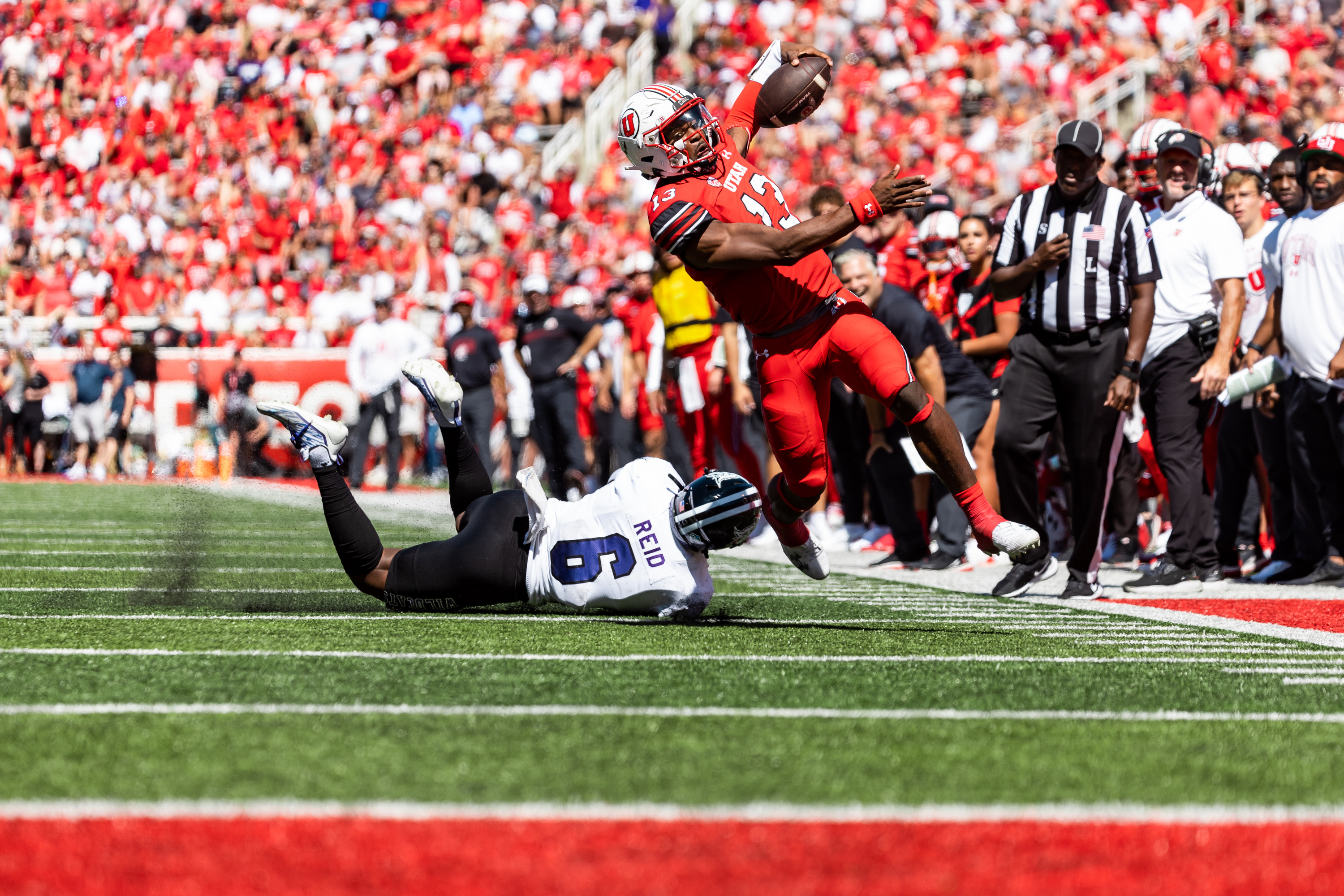 Utah Utes quarterback Nate Johnson (13) runs past Weber State Wildcats linebacker Winston Reid (6) during their football game at Rice-Eccles Stadium in Salt Lake City on Saturday, Sept. 16, 2023.