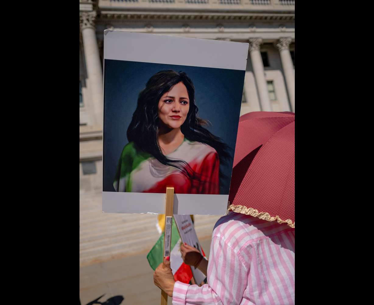 A woman holds a portrait of Mahsa Amini at a protest against the Iranian regime at the Capitol in Salt Lake City on Saturday. Amini died a year ago in the custody of Iran’s morality police after being arrested for allegedly violating the country’s strict dress code for women, sparking widespread protests.