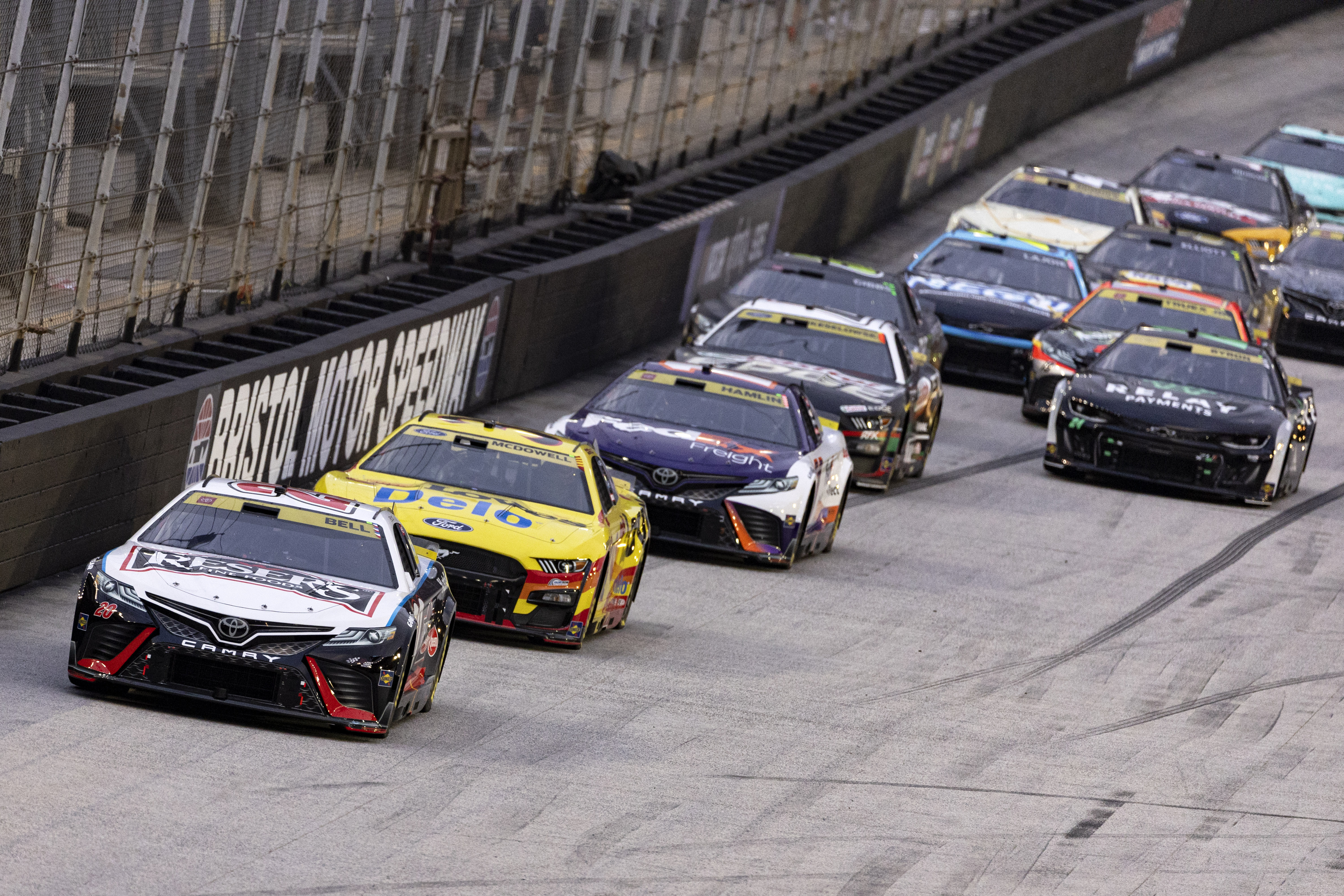 Chris Buescher (20) leads Michael McDowell, Denny Hamlin and the rest of the field during the NASCAR Cup Series auto race Saturday, Sept. 16, 2023, in Bristol, Tenn.