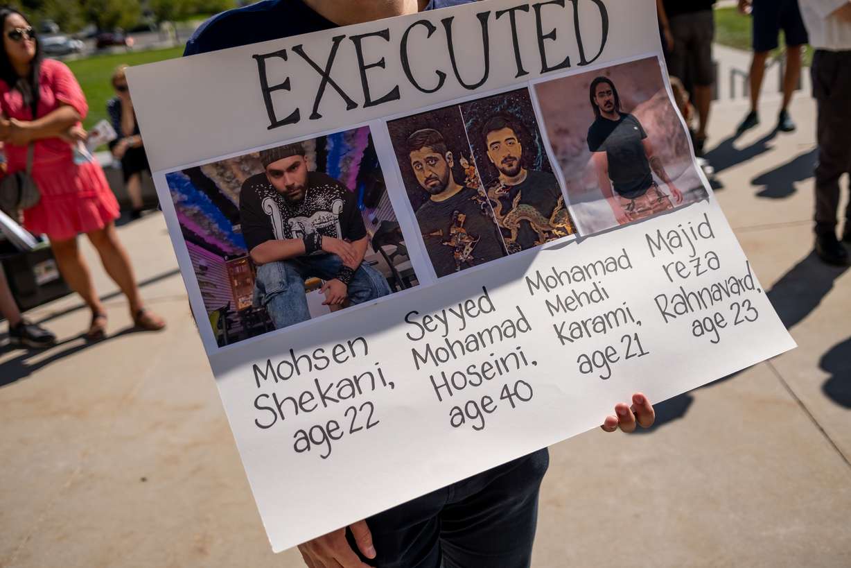 A protester holds a sign at the Capitol in Salt Lake City on Saturday. The sign shows images of protesters in Iran who have been killed during a protests against the Iranian regime The protest in Salt Lake City was held on the one-year anniversary of the death of Mahsa Amini, who was arrested by Iran’s morality police for allegedly violating the country’s strict dress code for women.
