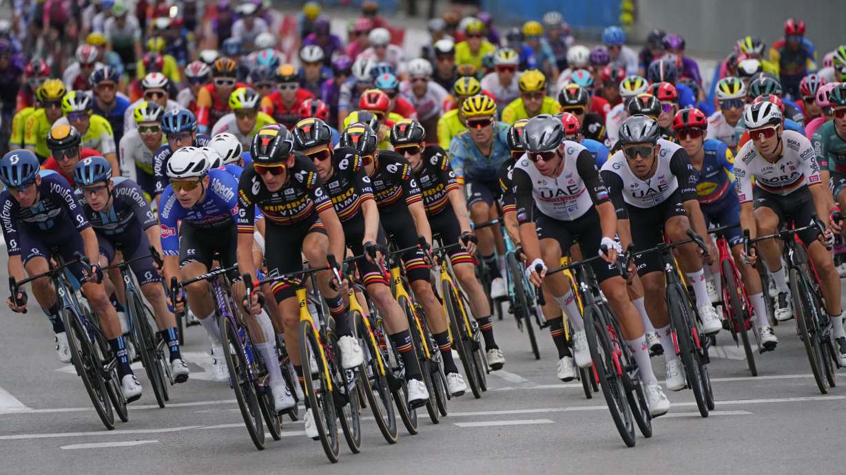 Cyclists compete during the 21st stage of the Vuelta cycling race between Hipodromo de La Zarzuela and Madrid, Spain, Sunday, Sept. 17, 2023.