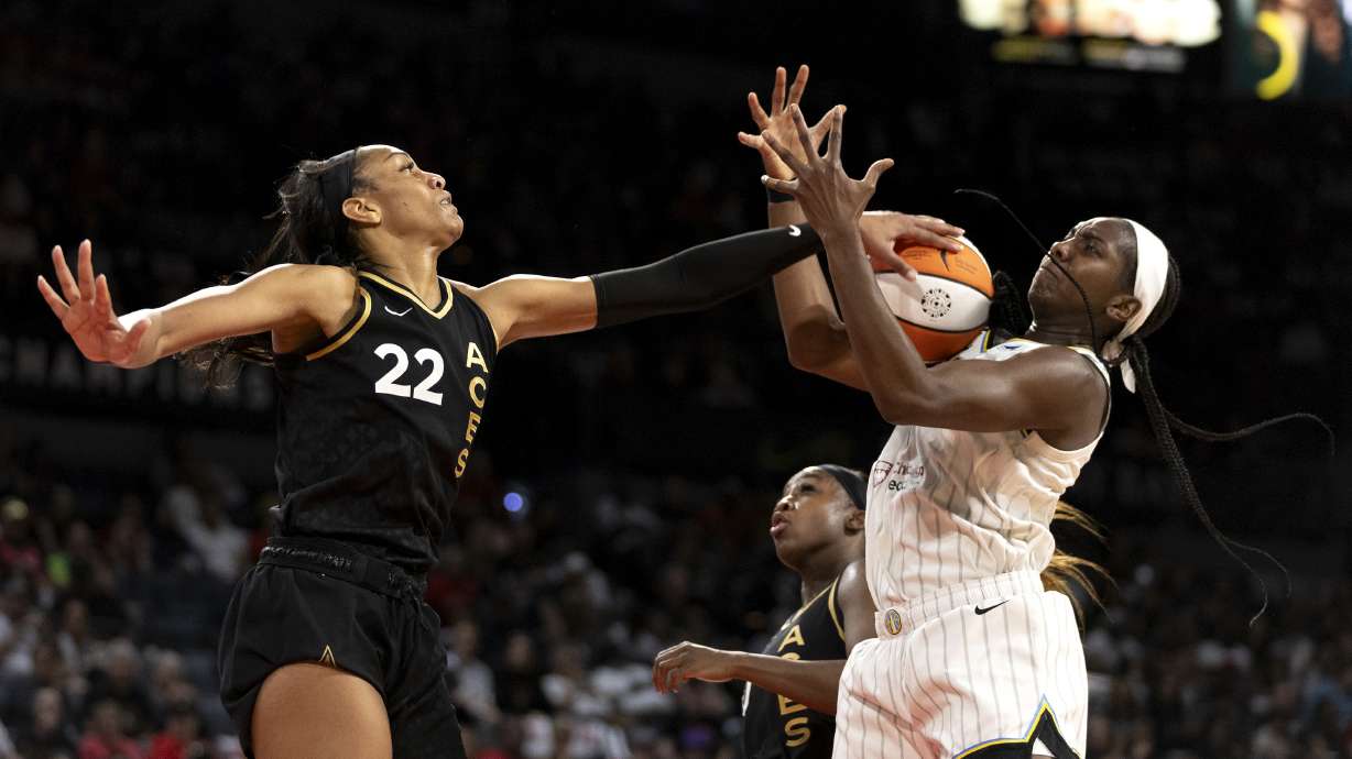 Las Vegas Aces forward A'ja Wilson (22) swats down a shot by Chicago Sky center Elizabeth Williams, right, during the first half of Game 2 of a WNBA basketball playoff series game, Sunday, Sept. 17, 2023, in Las Vegas.