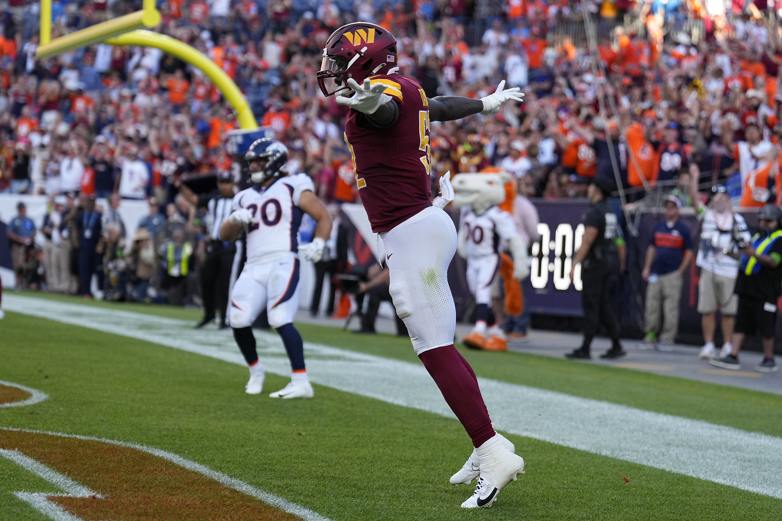 Washington Commanders linebacker Jamin Davis (52) celebrates after a failed two-point conversion-attempt by the Denver Broncos after time ran out in the fourth quarter of an NFL football game Sunday, Sept. 17, 2023, in Denver.