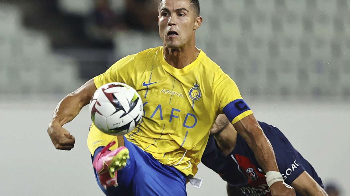 FILE - Al Nassr's Cristiano Ronaldo controls the ball during a friendly soccer match against Paris Saint-Germain in Osaka, western Japan, Tuesday, July 25, 2023. Cristiano Ronaldo, Neymar and Karim Benzema have won a combined total of 11 UEFA Champions League titles and, starting Monday, Sept. 18, 2023, they lead the Saudi Arabian challenge in the Asian edition.
