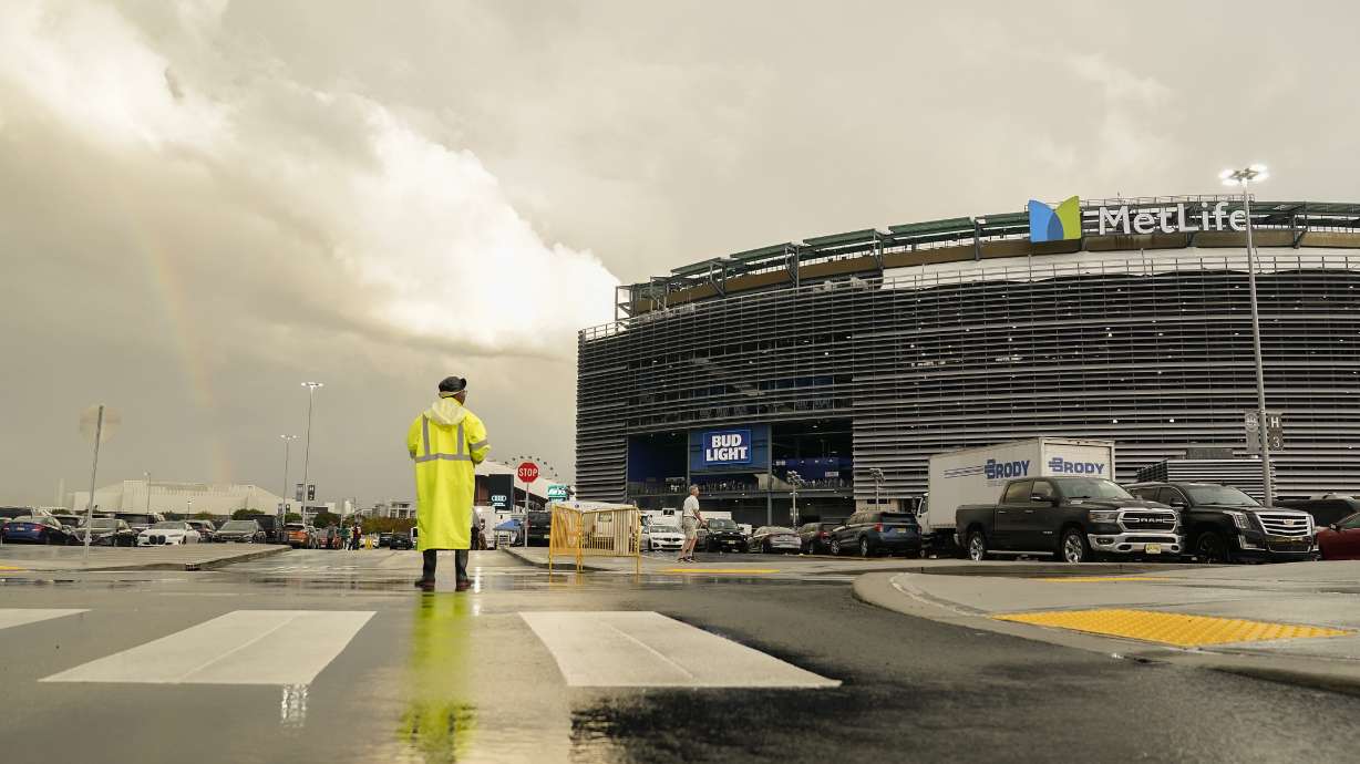 A parking attendant views a rainbow outside Met Life stadium before an NFL football game between the New York Jets and the Buffalo Bills, Monday, Sept. 11, 2023, in East Rutherford, N.J.
