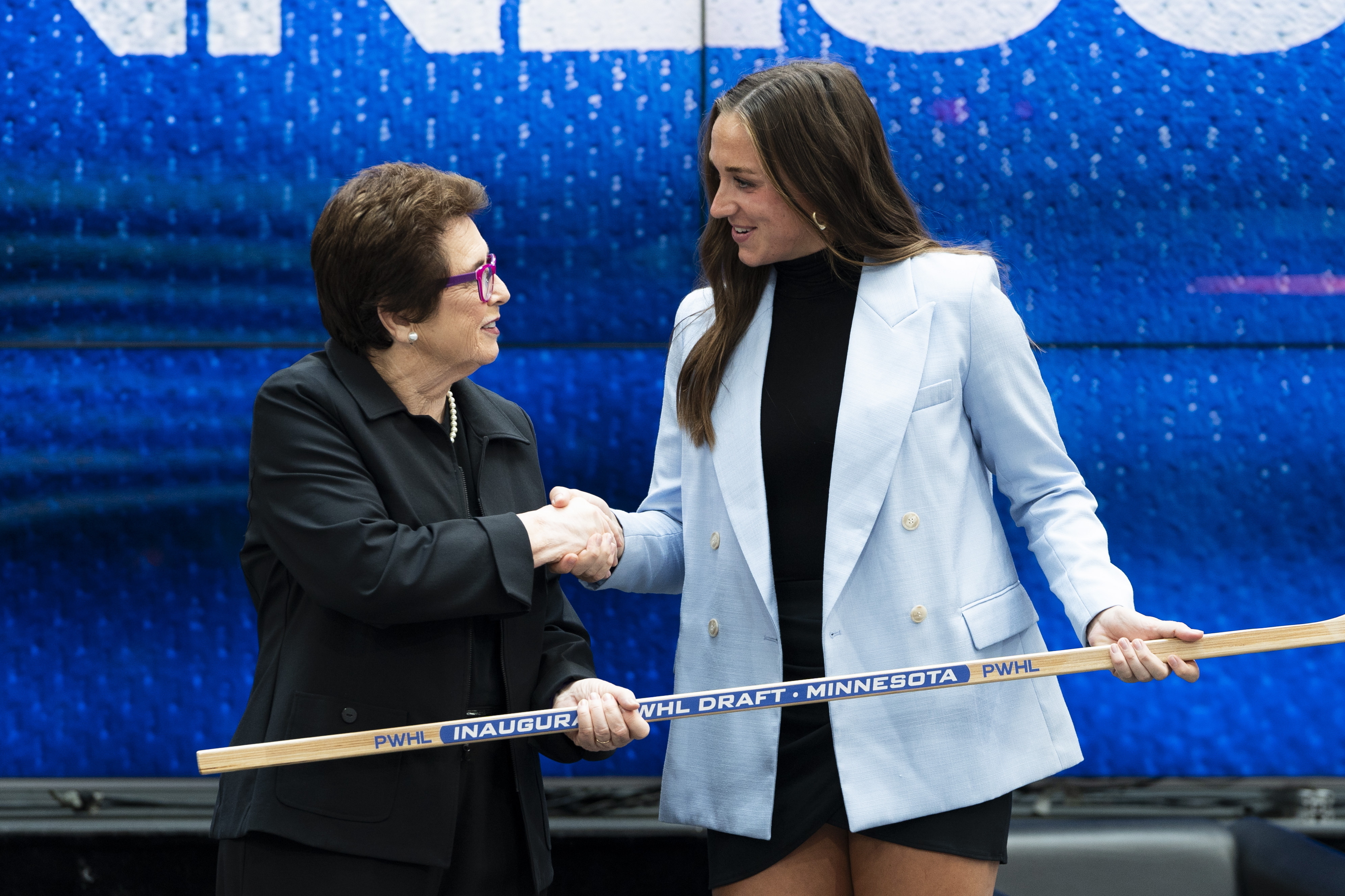 Minnesota's Tayler Heise, right, shakes hands tennis legend Billie Jean King after being selected first overall in the inaugural Professional Women's Hockey League draft in Toronto, Monday, Sept. 18, 2023. 