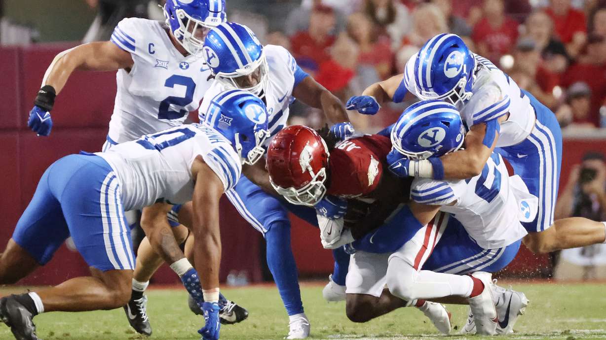 The Brigham Young Cougars defense tackle Arkansas Razorbacks wide receiver Andrew Armstrong (2) at Razorback Stadium in Fayetteville on Saturday, Sept. 16, 2023.