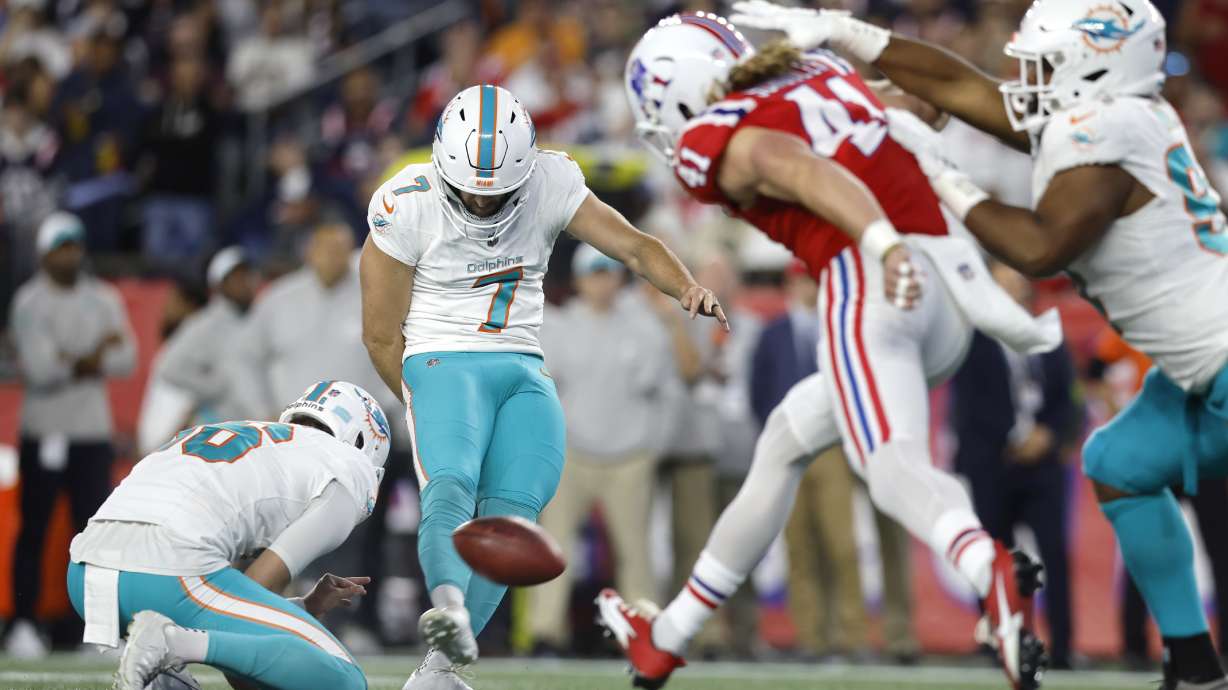 Miami Dolphins place kicker Jason Sanders (7) hits a field goal while pressured by New England Patriots safety Brenden Schooler (41) during the first half of an NFL football game, Sunday, Sept. 17, 2023, in Foxborough, Mass.