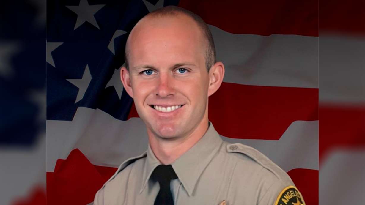 Los Angeles County Sheriff's Department Deputy Ryan Clinkunbroomer died after he was shot in his patrol car Saturday evening by an unknown assailant and an investigation is underway that the sheriff said will press all of the department’s resources into action.