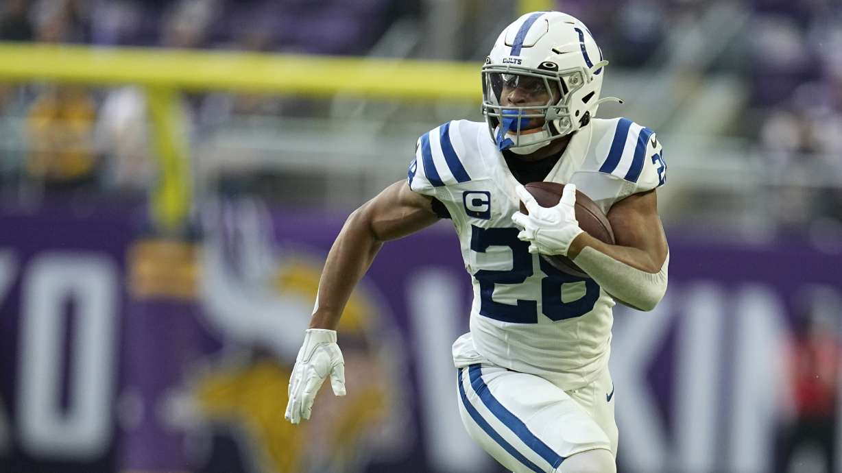 FILE -Indianapolis Colts running back Jonathan Taylor runs up field during the first half of an NFL football game against the Minnesota Vikings, Saturday, Dec. 17, 2022, in Minneapolis. The NFL has filed a grievance against the NFL Players Association, alleging that union leaders, including President JC Tretter, have advised running backs to “consider feigning or exaggerating injuries” to help increase their leverage in contract negotiations. The grievance was filed on Sept. 11, 2023