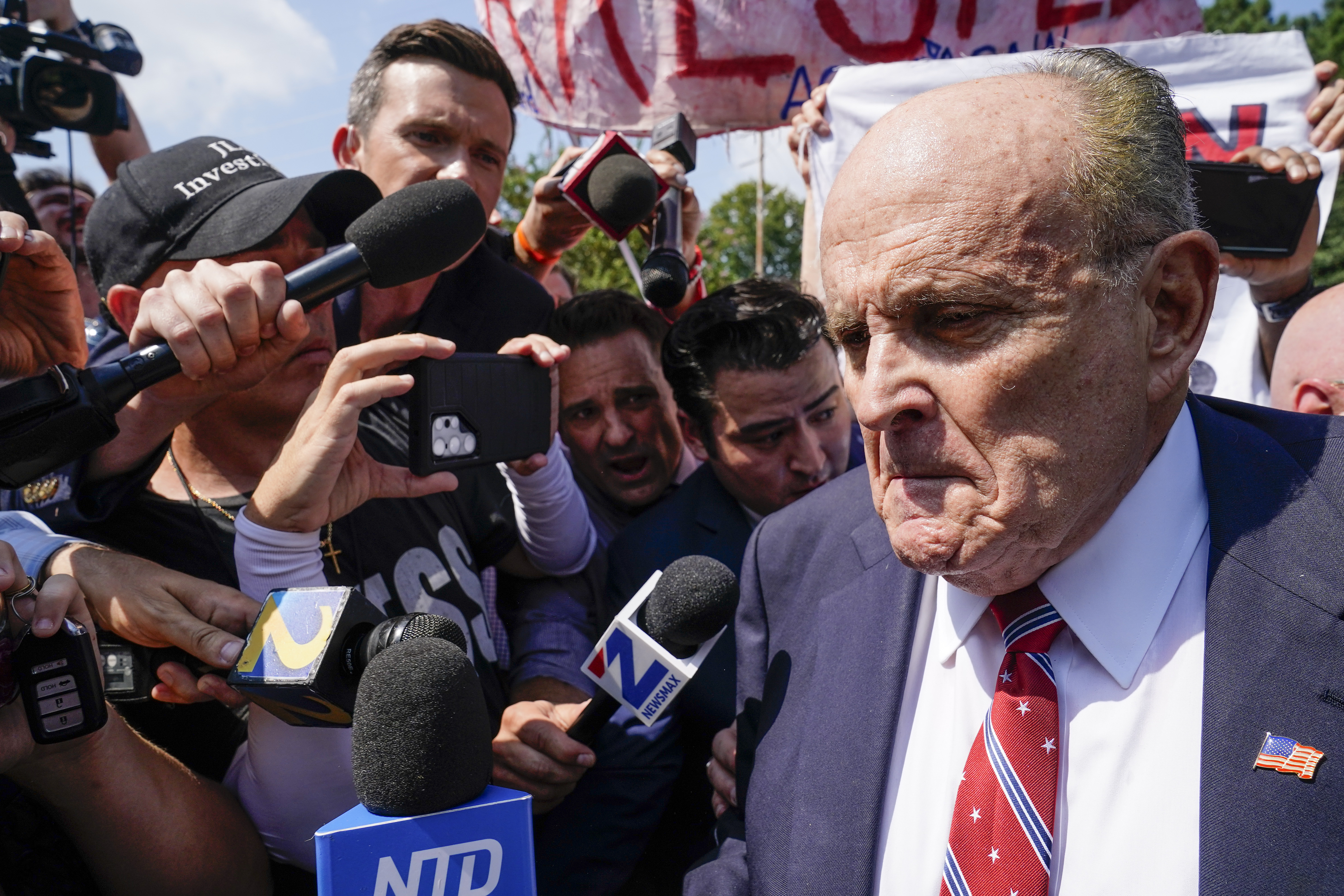 Rudy Giuliani speaks outside the Fulton County jail, Aug. 23, in Atlanta. Giuliani's former lawyer sued him Monday, alleging the ex-New York City mayor has paid only a fraction of nearly $1.6 million in legal fees.