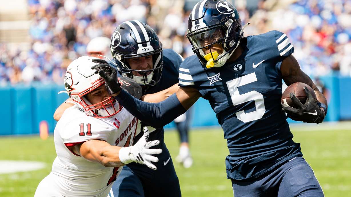 Brigham Young wide receiver Darius Lassiter (5) passes Southern Utah safety George Ramirez (11) to run the ball into the end zone for a BYU touchdown at LaVell Edwards Stadium in Provo on Saturday, Sept. 9, 2023.
