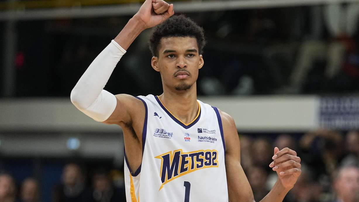 FILE - Boulogne-Levallois' Victor Wembanyama celebrates after a dunk against Lyon-Villeurbanne during a basketball game in Levallois, France, on Jan. 9, 2023. Wembanyama will be aiming for the gold medal at the Paris Olympics. The San Antonio Spurs rookie reaffirmed his commitment to France's national squad at the Summer Games next year. He spoke in the wake of France’s poor showing at the World Cup last month, where he did not play.