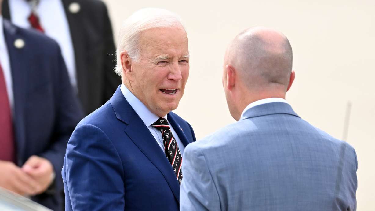 President Joe Biden talks with Gov. Spencer Cox after his arrival on Air Force One in Salt Lake City on Aug. 9. Cox on Tuesday joined a letter asking the White House for more transparency around border crossings.