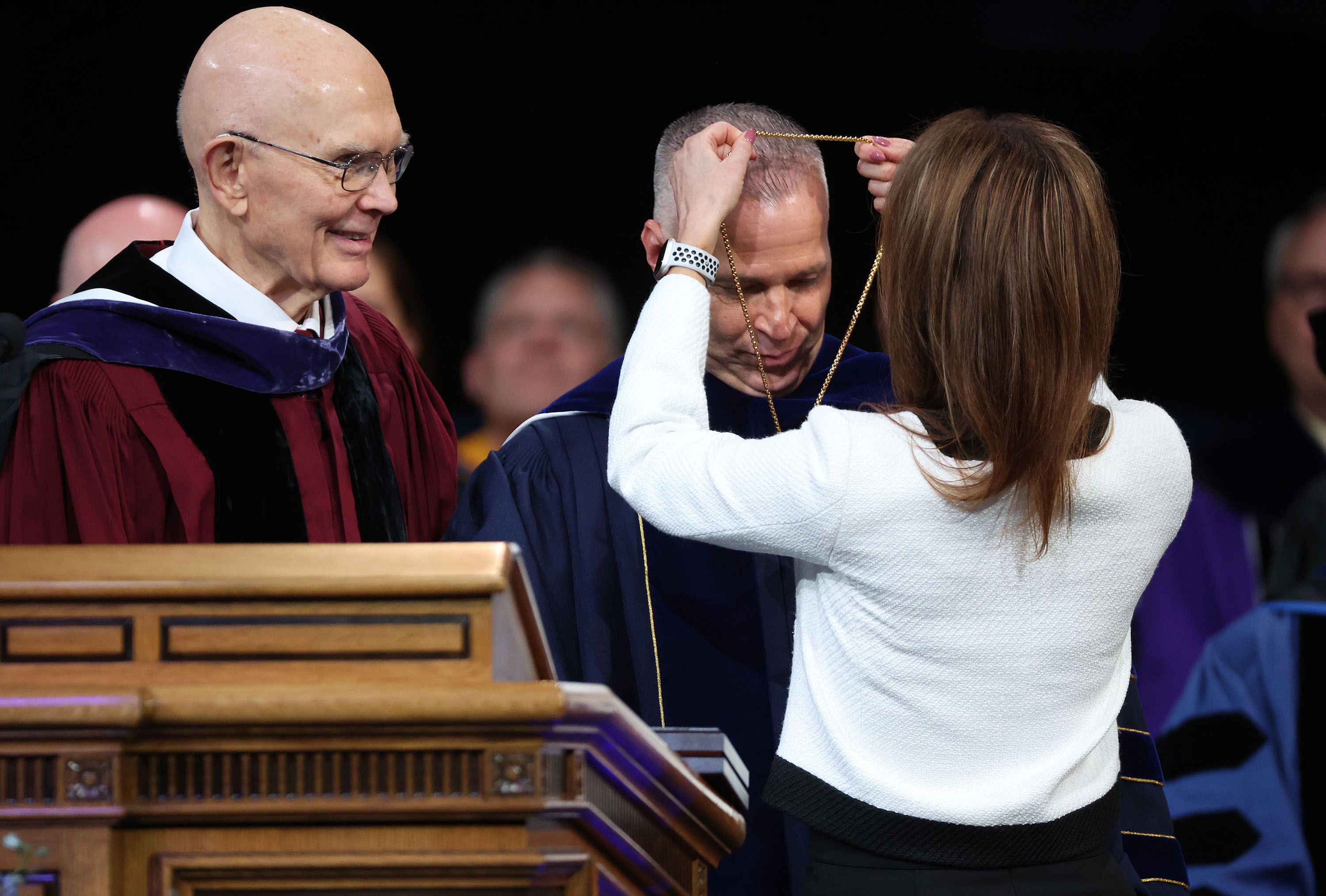 Wendy Reese places the presidential medallion on BYU President C. Shane Reese during his installation as BYU’s 14th president at the Marriott Center in Provo on Tuesday, as President Dallin H. Oaks, first counselor in the First Presidency of The Church of Jesus Christ of Latter-day Saints, looks on.